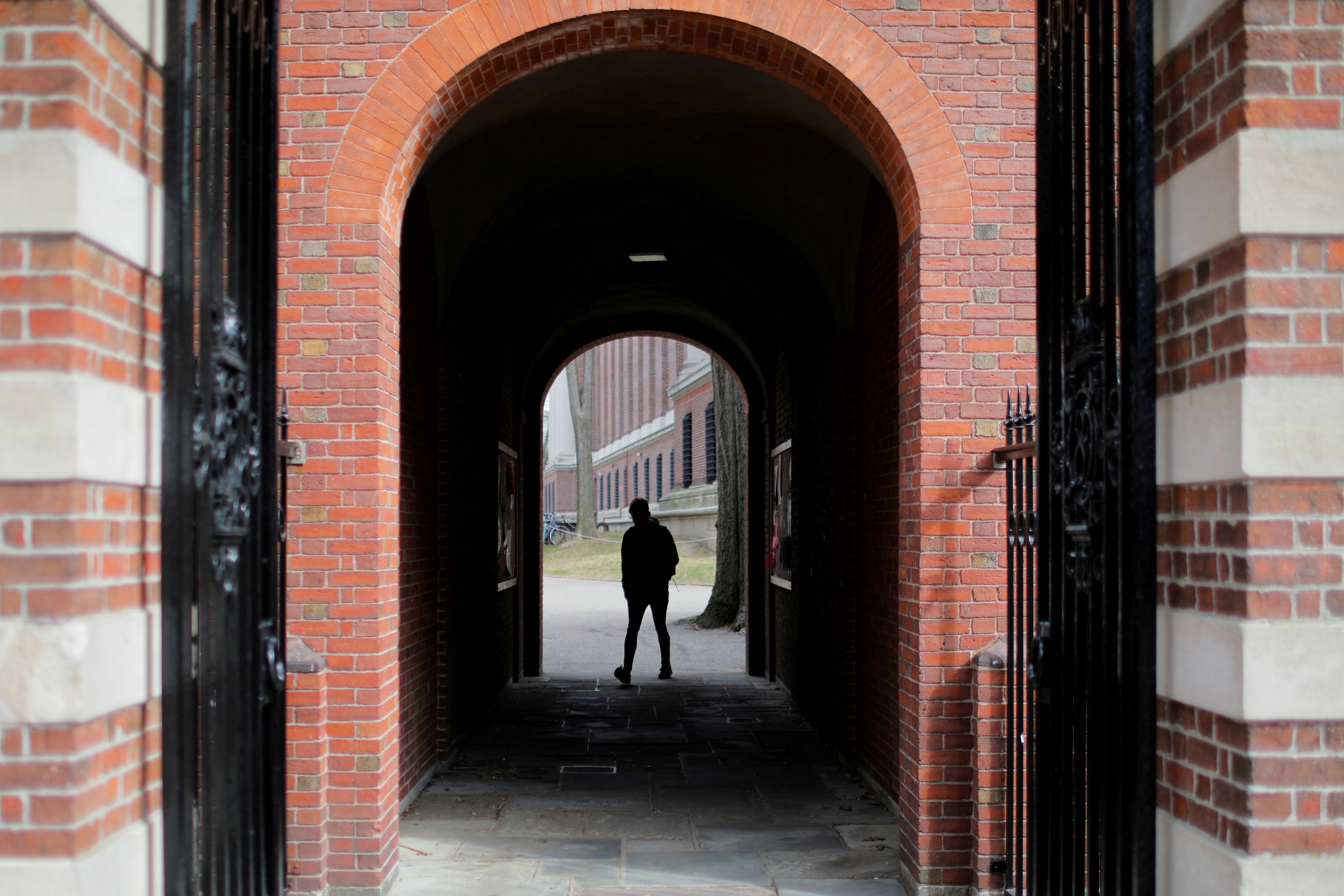 A man walks through a gate to the Yard at Harvard University in Cambridge, Massachusetts, in March. Photo: Reuters