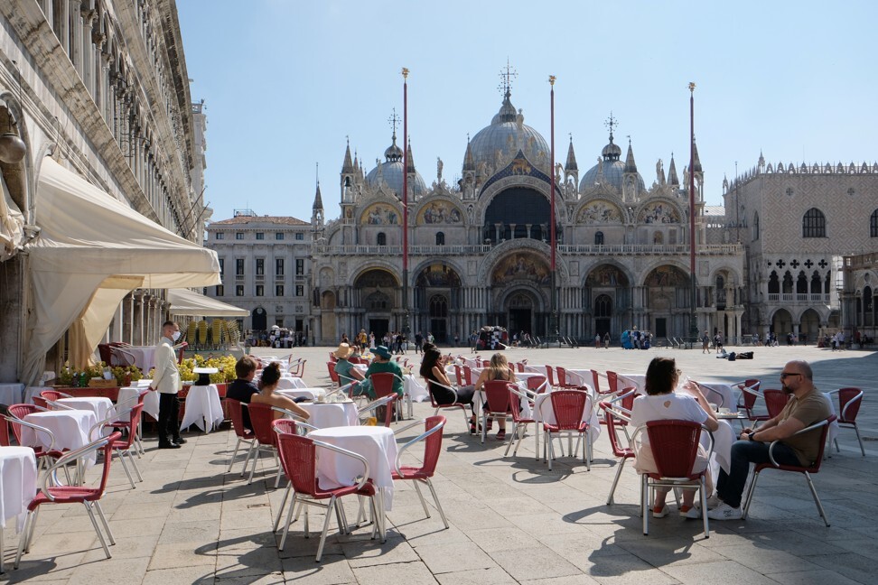 Tourists sit outside at a cafe in St Mark’s Square in Venice on June 14. A resurgence of Covid-19 cases across Europe has dimmed prospects for the continent’s hotel industry. Photo: Reuters