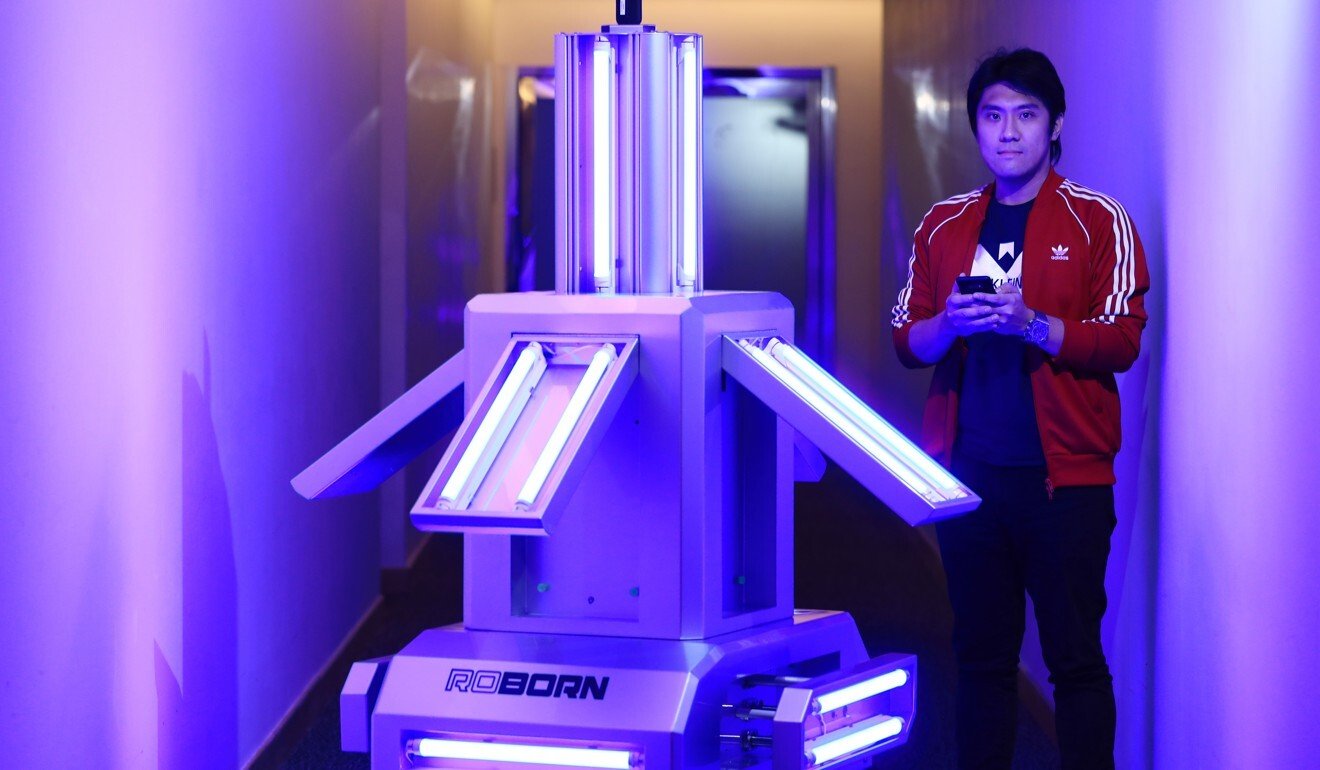 Mark Mak, co-founder of Roborn Technology, with Unicorn, its ultraviolet light emitting robot, which can be used to kill 99.9 per cent of Covid-19 particles. Photo: SCMP/May Tse