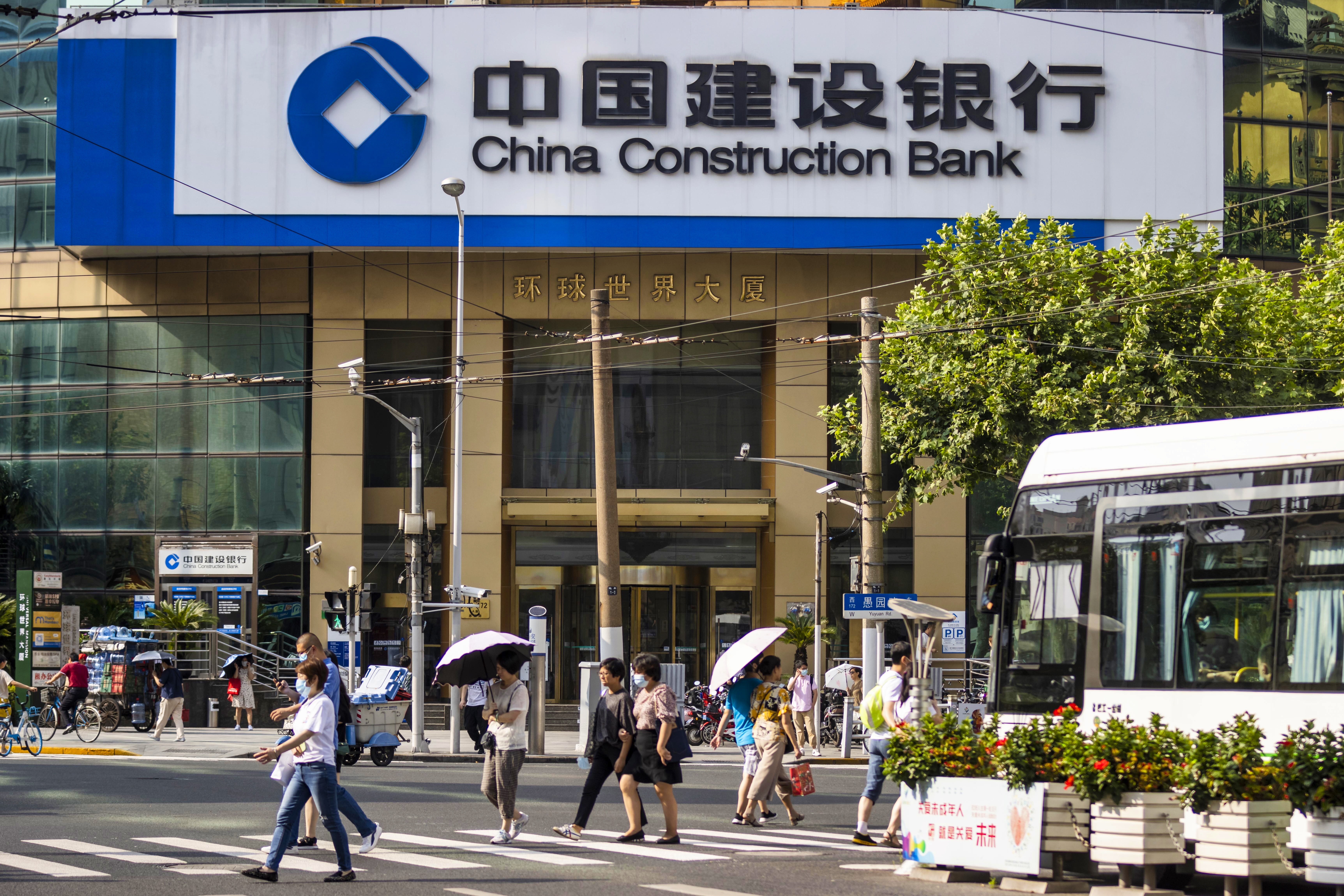 People walk in front of the China Construction Bank branch in Shanghai in August 2020. The lender has decided not to proceed with a digital bond issue on blockchain without an explanation. Photo: EPA-EFE