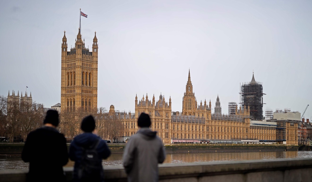 People gaze at Britain’s Houses of Parliament, incorporating the House of Lords and the House of Commons, in central London in December 2019. In 2005, the Supreme Court was created to replace the Appellate Committee of the House of Lords as the country’s highest court. Photo: AFP