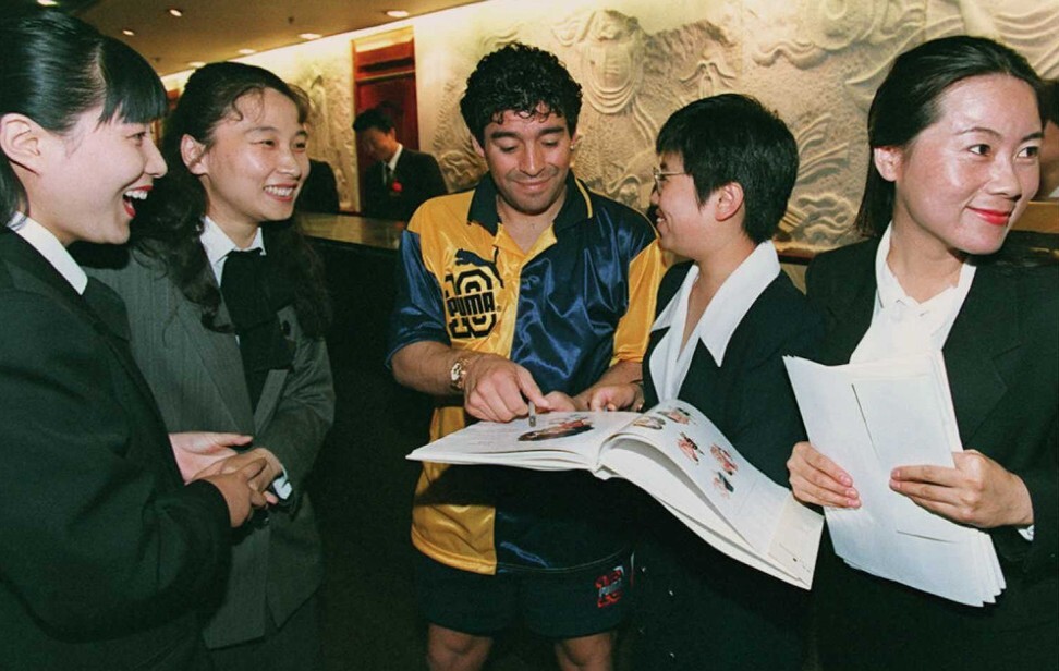 Maradona signs autographs for a group of Chinese hotel receptionists during a week-long tour of China with his team Boca Juniors in 1996. Photo: AFP