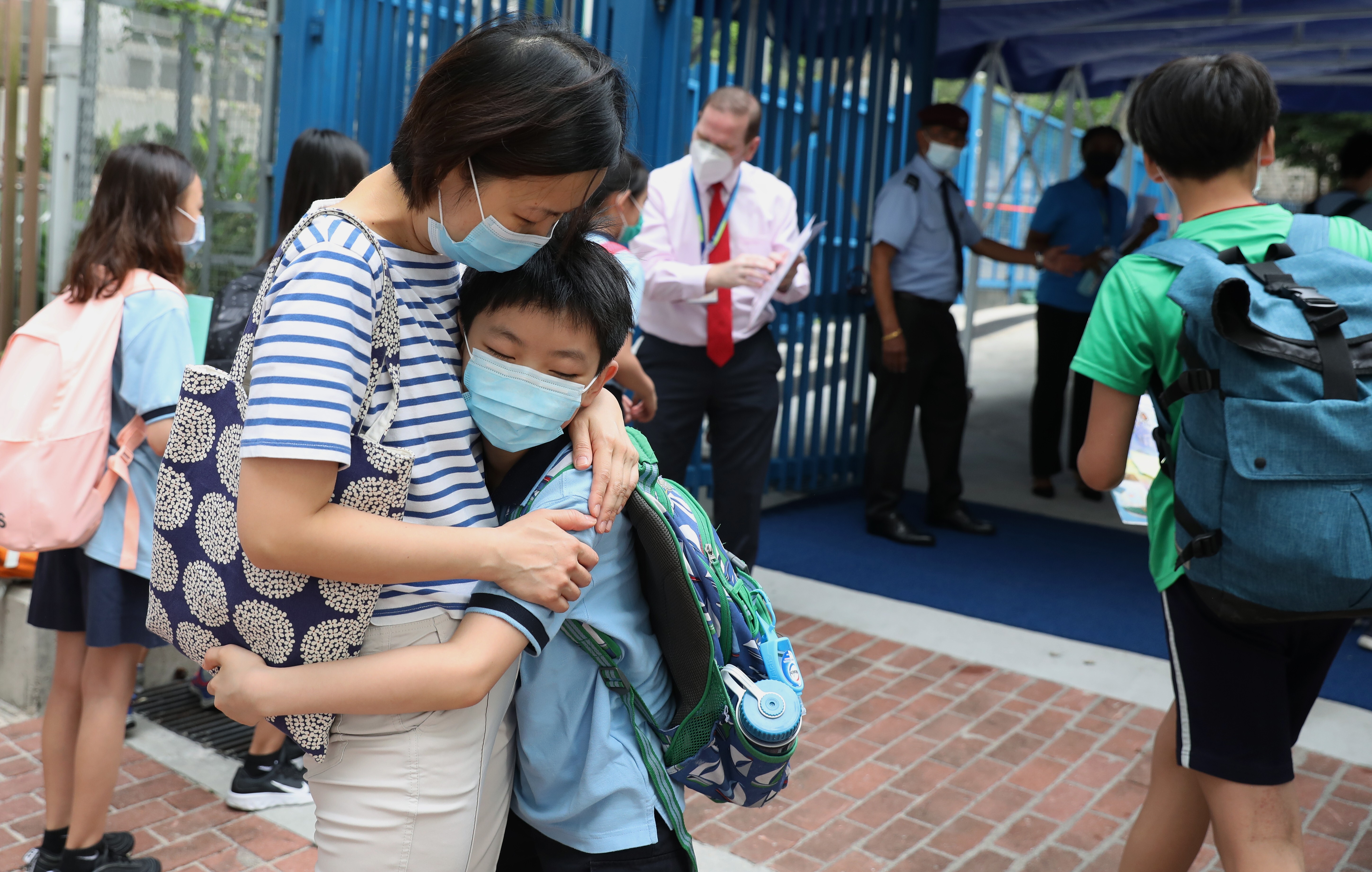 A mother hugs her son goodbye outside a school in Tai Kok Tsui on the first day back to school after coronavirus closures on May 29. Many Hong Kong parents are anxious about a suspension of face-to-face teaching once again now that the city has entered the fourth wave of Covid-19. Photo: Nora Tam