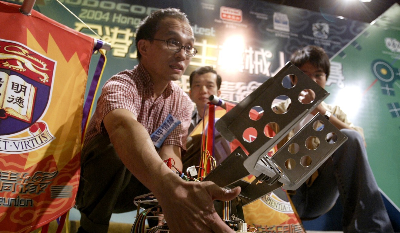 A young Cheung inspects a robot designed by students in 2004. Photo: Dickson Lee