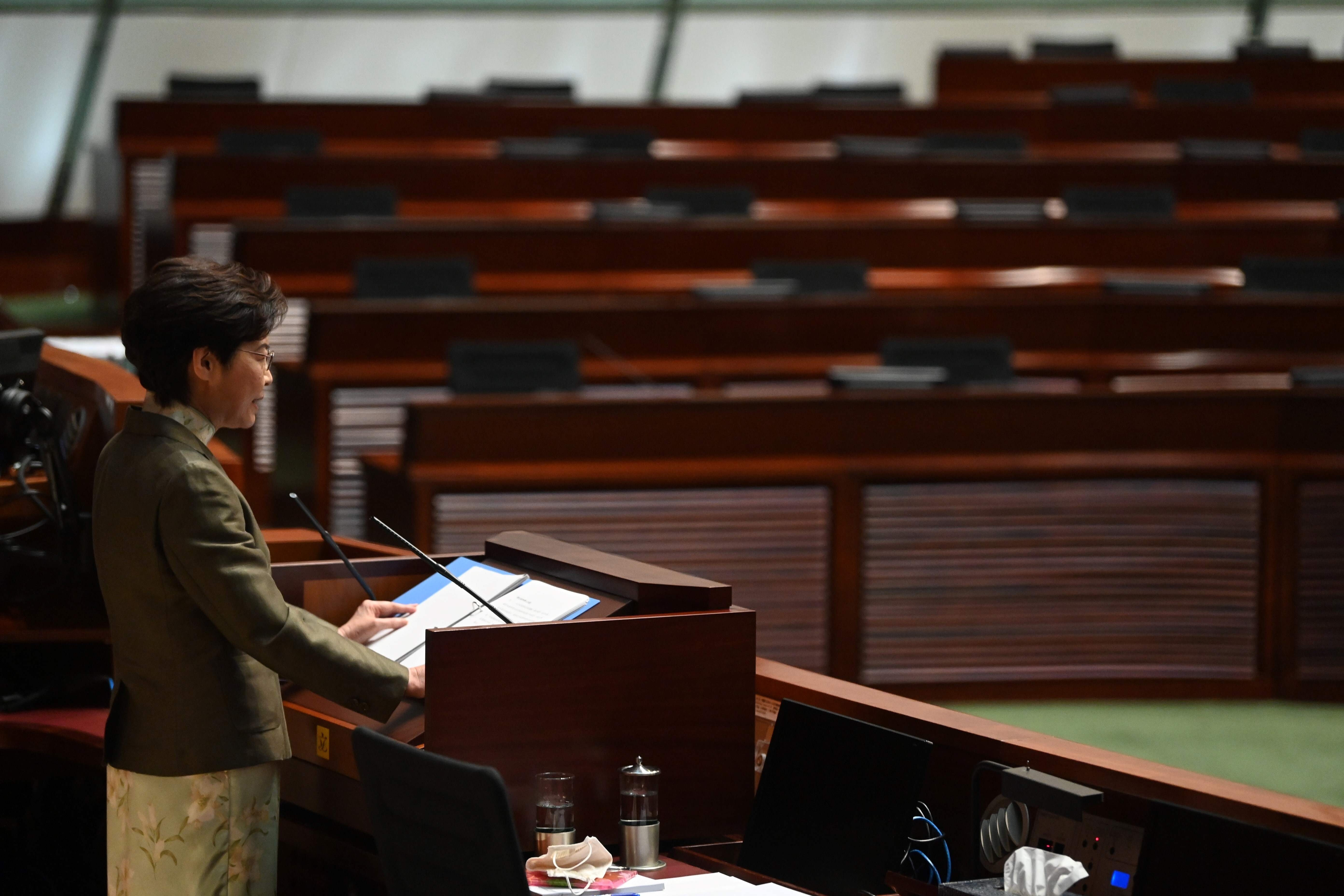 Hong Kong Chief Executive Carrie Lam gives her annual policy address in front of seats once occupied by opposition members. Photo: AFP