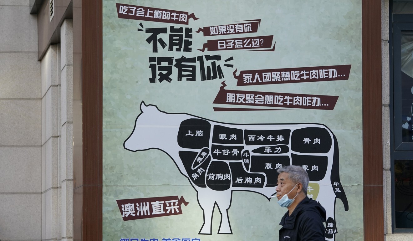 A man walks past an advertisement promoting imported beef from Australia in Beijing on November 23. China recently banned imports from five Australian meat processing plants. Photo: AP