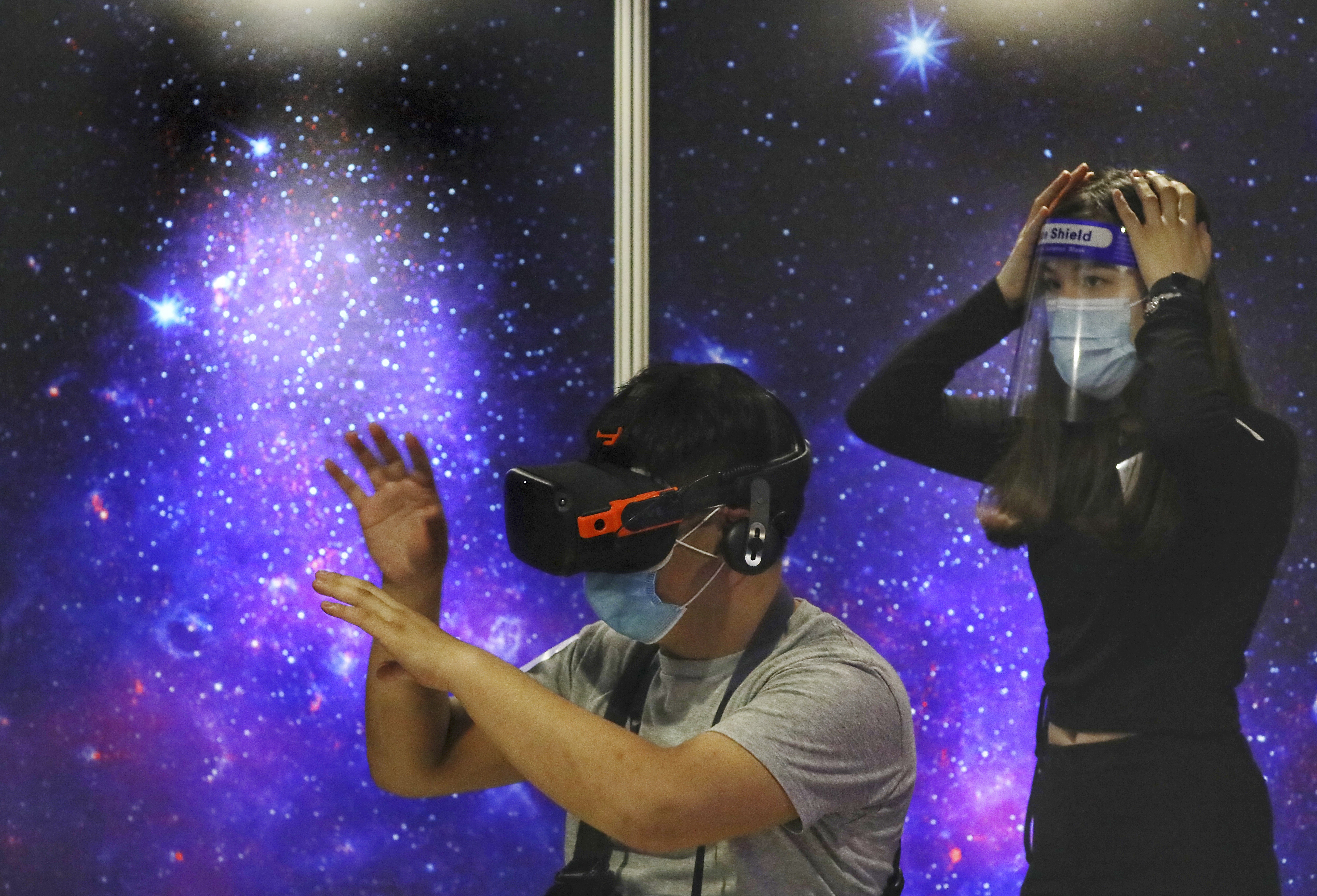 Visitors try out a virtual reality exhibition, “Univers/e”, at the Hong Kong Space Museum in Tsim Sha Tsui. Photo: Nora Tam