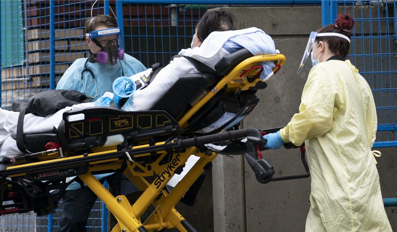Medical personnel wear personal protective equipment to help prevent the spread of Covid-19 as they wheel a patient into St Paul‘s Hospital in downtown Vancouver, British Columbia, on November 23. Photo: AP