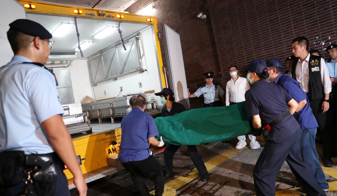 The police remove the body of Tina Chan Wai-man from the campus of the University of Hong Kong, where it was discovered in her husband's office.  Photo: KY Cheng