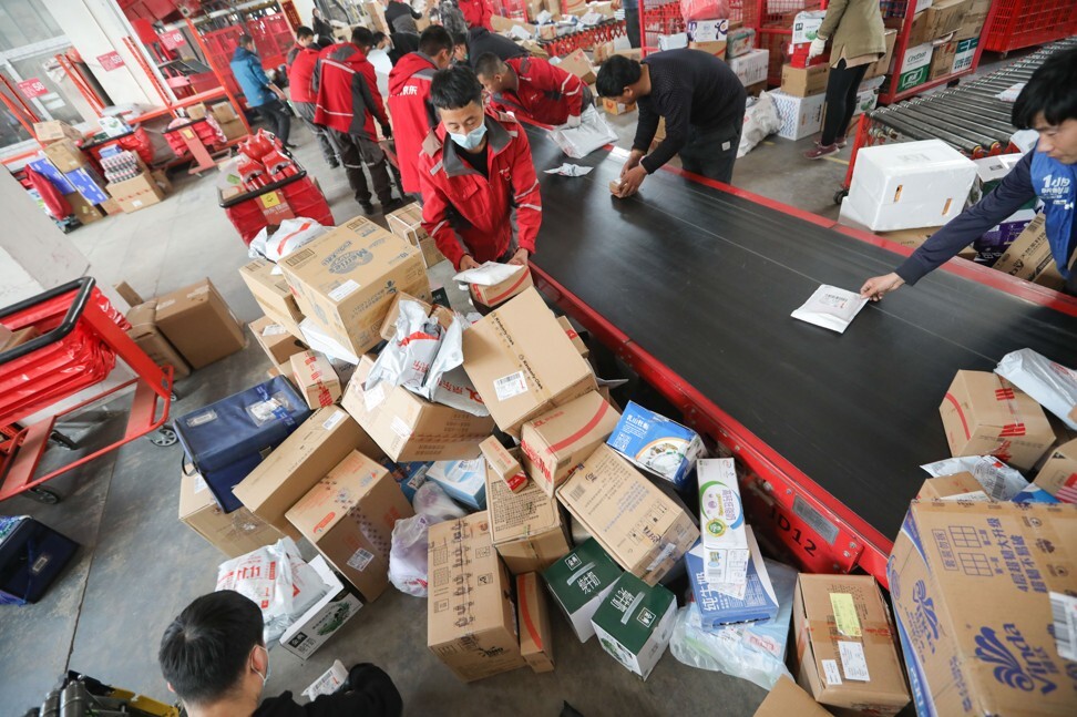 Workers sort out packages for delivery at JD's Yizhuang Smart Delivery Station in Beijing on November 11, during the Singles' Day shopping festival. Photo: Simon Song