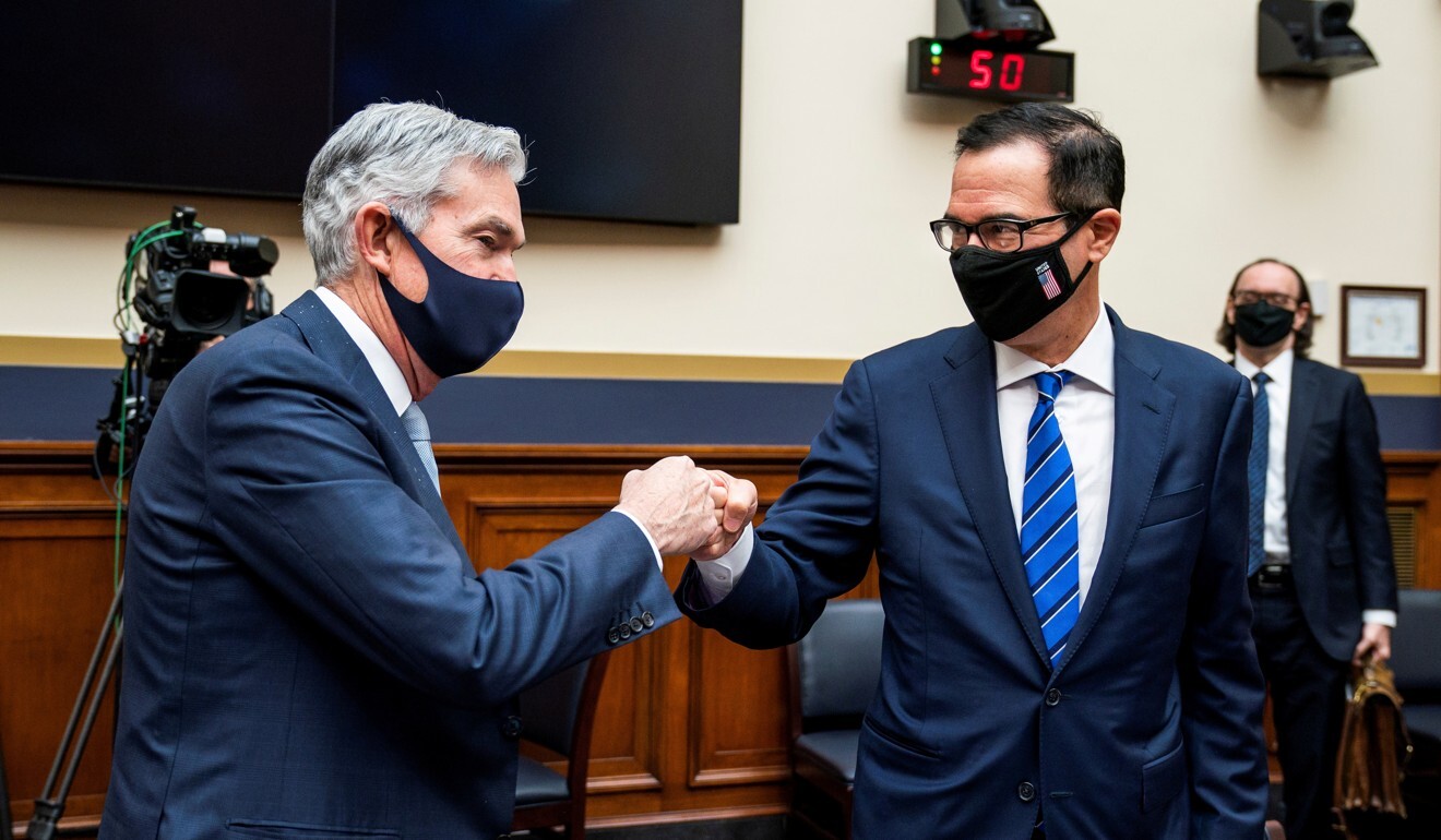 Federal Reserve chairman Jerome Powell and Treasury Secretary Steven Mnuchin bump fists after a House Financial Services Committee hearing in Washington on December 2. Photo: Reuters