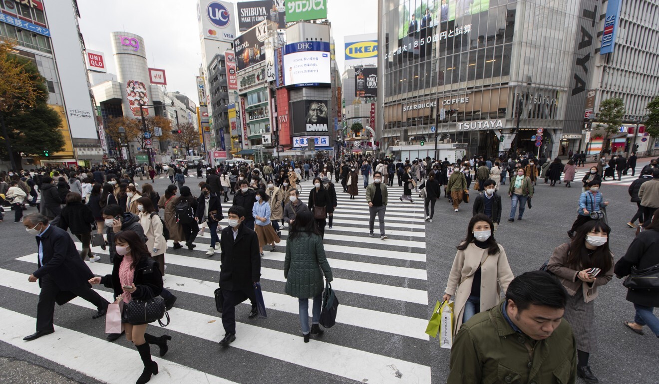 Tokyo is reaching new highs in daily Covid-19 cases as its people continue to wear masks on in public. Photo: AP