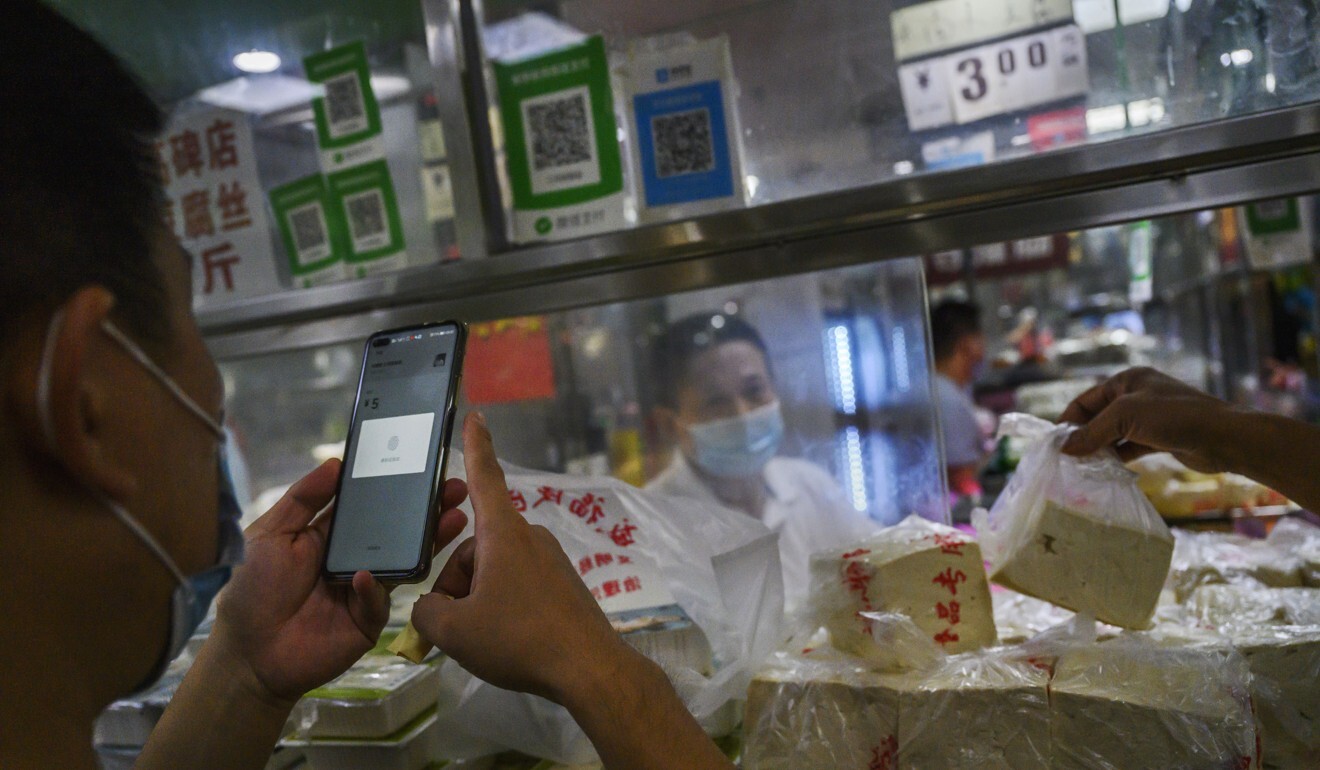 A customer uses his mobile phone to pay via a QR code using the WeChat app at a Beijing market. Elderly street vendor Zhang Baohua uses a QR code to receive payment for the salted duck eggs he sells, but has no idea where the money goes or how to retrieve it. Photo: Kevin Frayer/Getty Images A customer uses his mobile phone to pay via a QR code using the WeChat app at a Beijing market. Elderly street vendor Zhang Baohua uses a QR code to receive payment for the salted duck eggs he sells, but has no idea where the money goes or how to retrieve it. Photo: Kevin Frayer/Getty Images