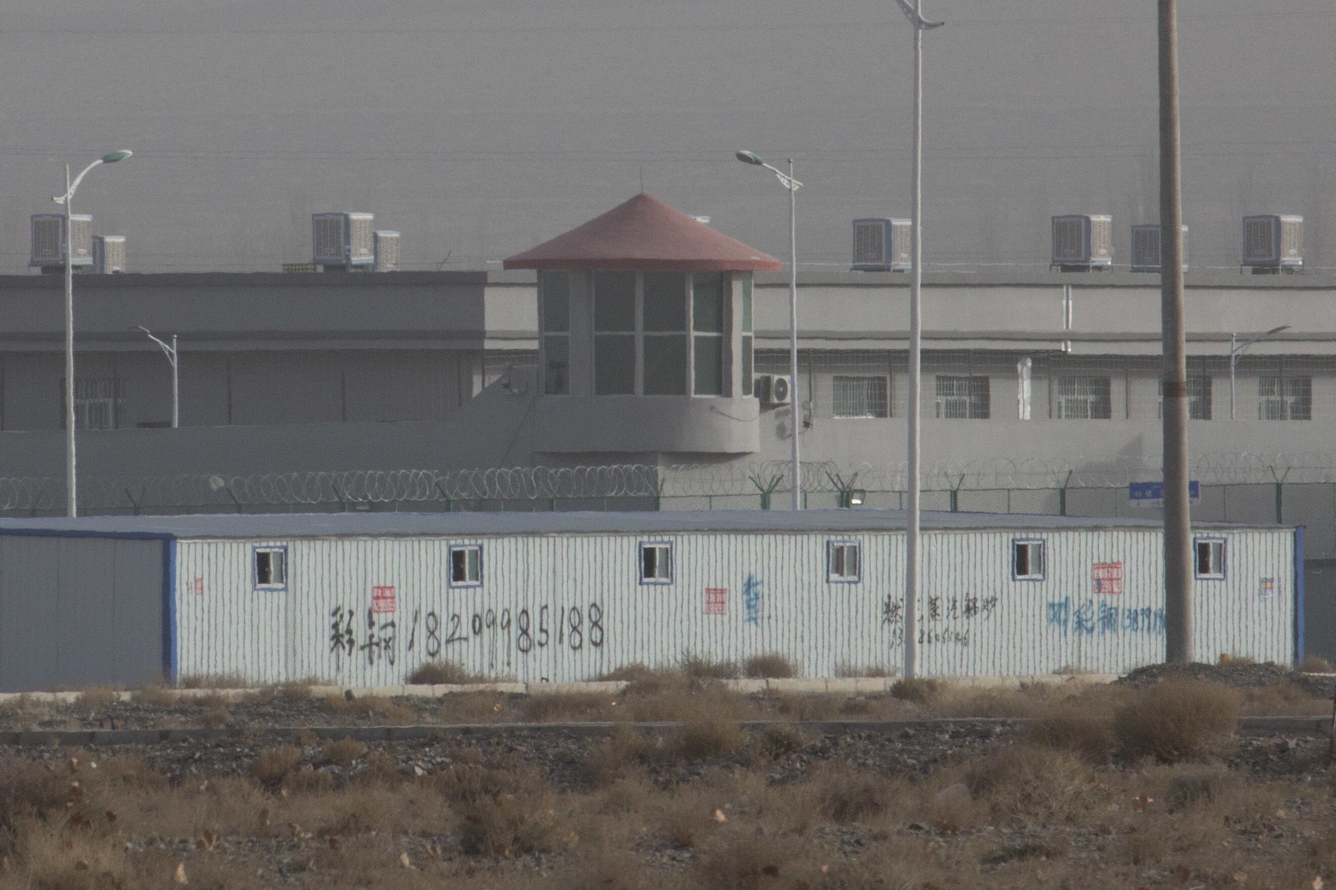 A guard tower and barbed wire fences are seen around a facility in the Kunshan Industrial Park in Artux, Xinjiang. China has denied allegations of human rights abuses. Photo: AP