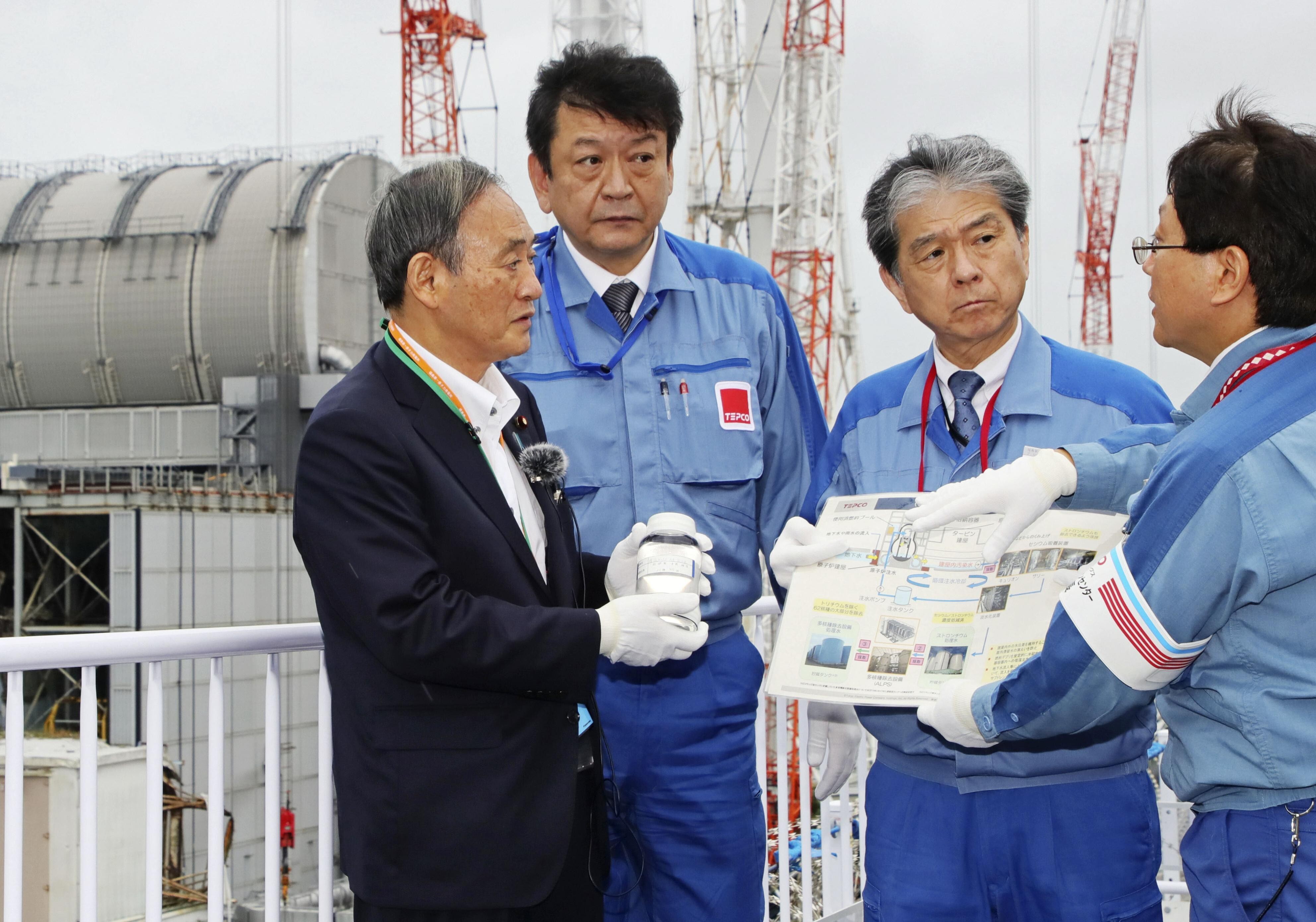 Japanese Prime Minister Yoshihide Suga, left, visits the disaster-stricken Fukushima Daiichi nuclear power plant Japan in September. Photo: Kyodo