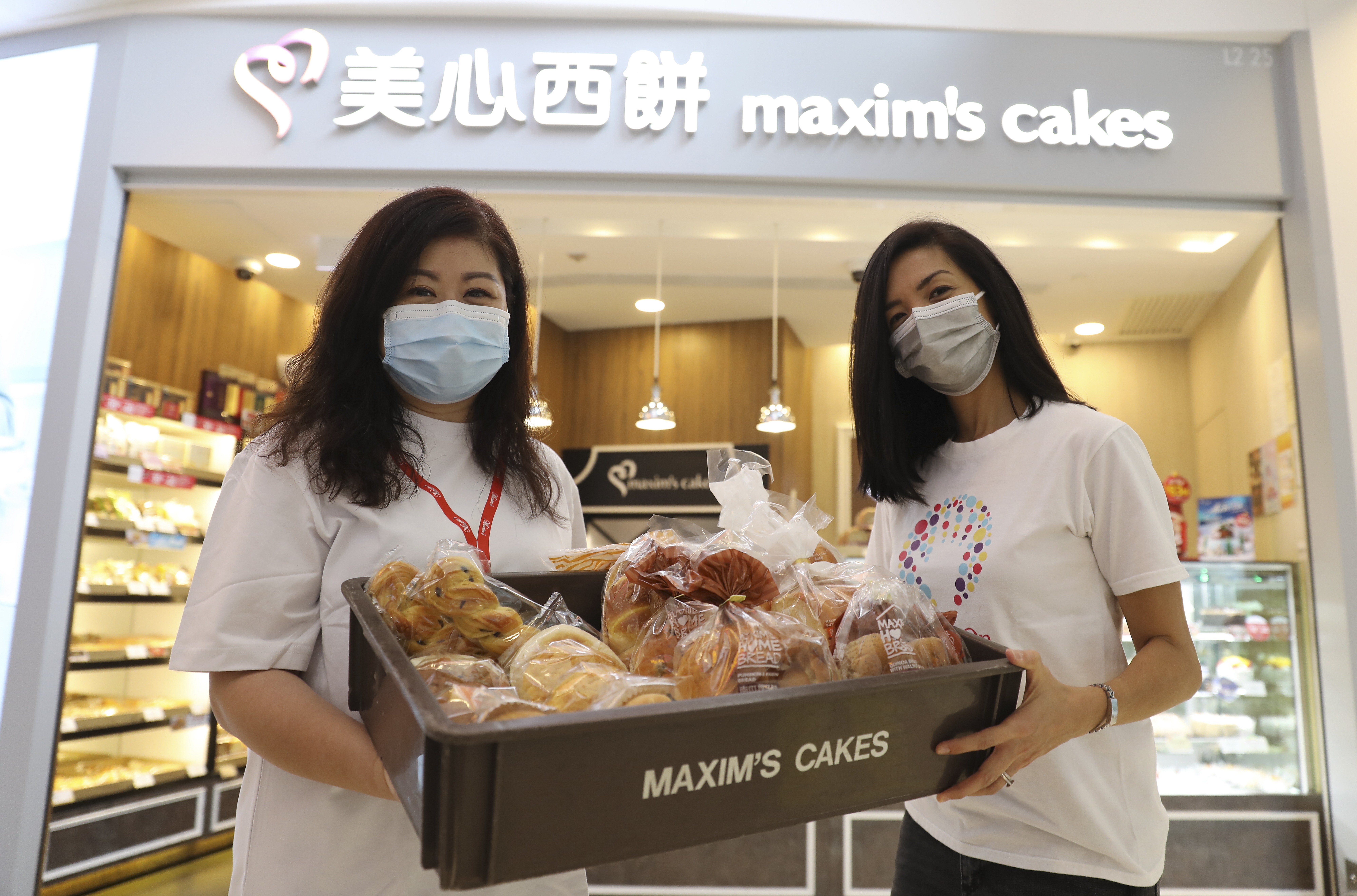 Maxim’s Group district manager (cakes and bakery) Kennis Hung (left) and HandsOn Hong Kong associate director Catherine Dannaoui in V-Walk Mall, Cheung Sha Wan. Photo: May Tse
