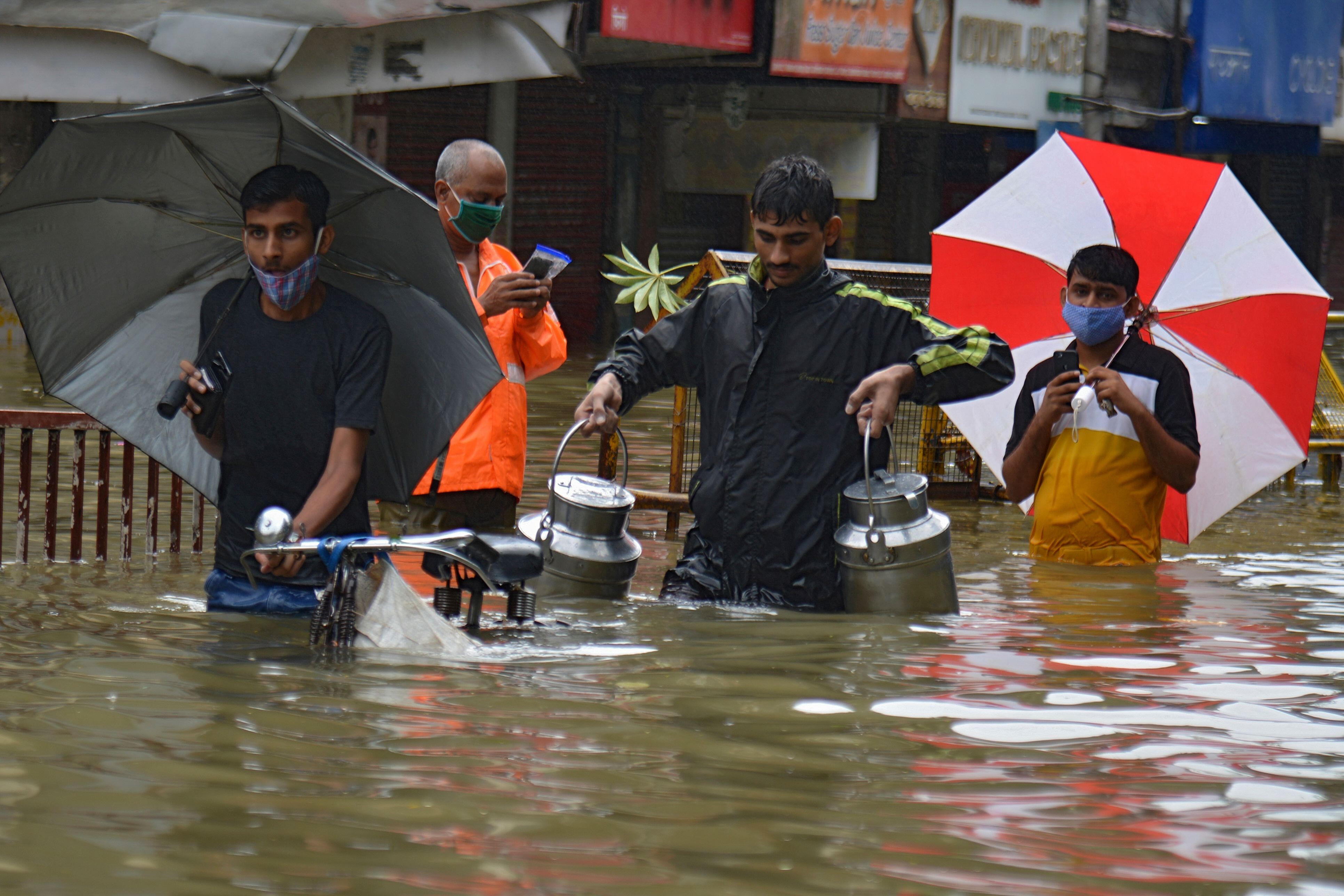 People wade through a flooded street following heavy monsoon rains in Mumbai on September 23. Photo: AFP