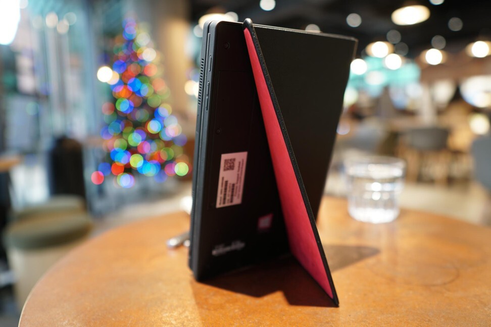 The leather cover of the Lenovo ThinkPad X1 Fold has a hidden flap that doubles as a kickstand, allowing the tablet computer to be able to stand on its own. Photo: Ben Sin