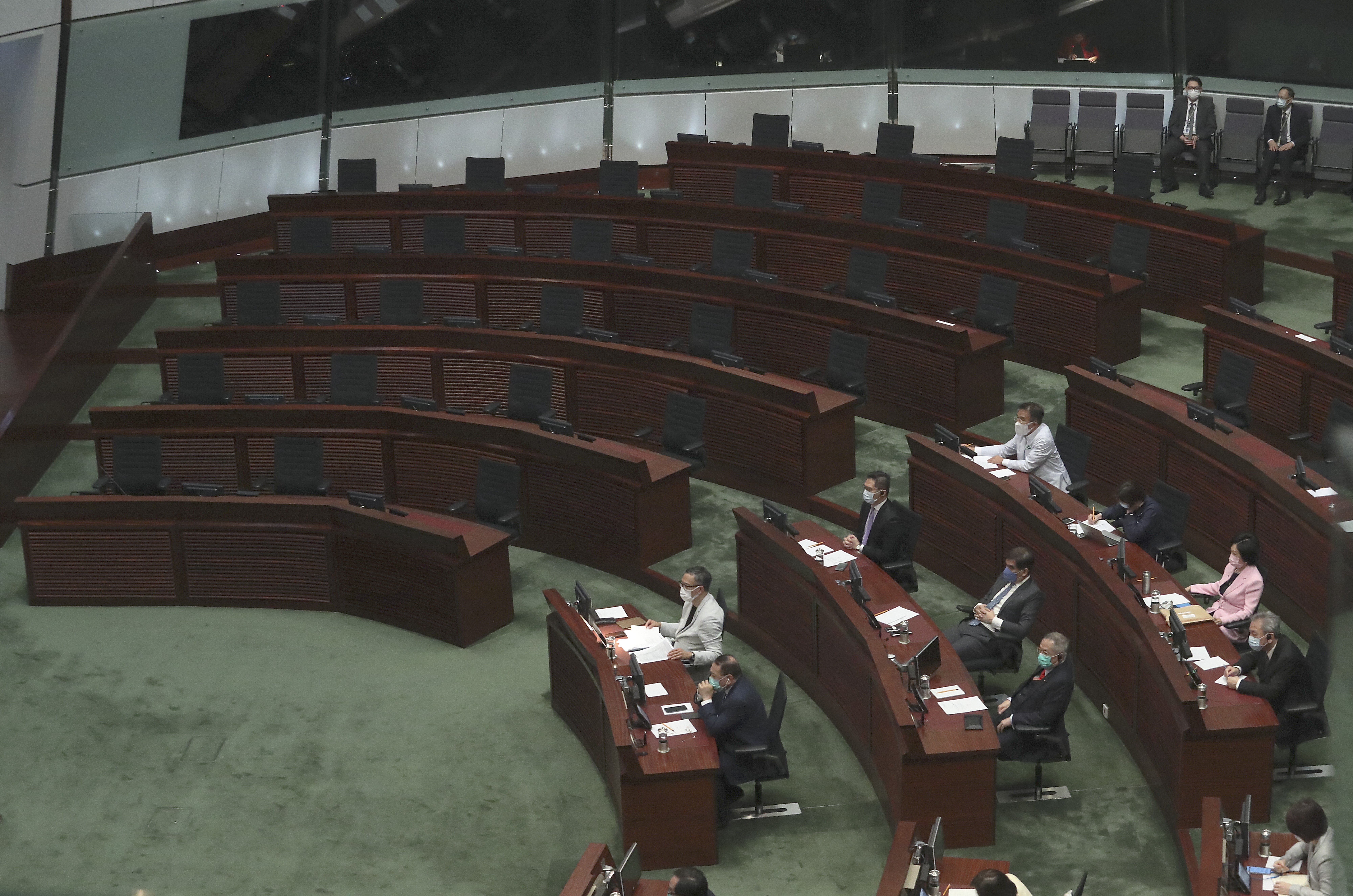 Hong Kong lawmakers listen as Hong Kong’s 2020 policy address is delivered in the Legislative Council chamber on November 25. The empty seats on the left are where the pan-democratic camp used to be seated. Photo: Dickson Lee