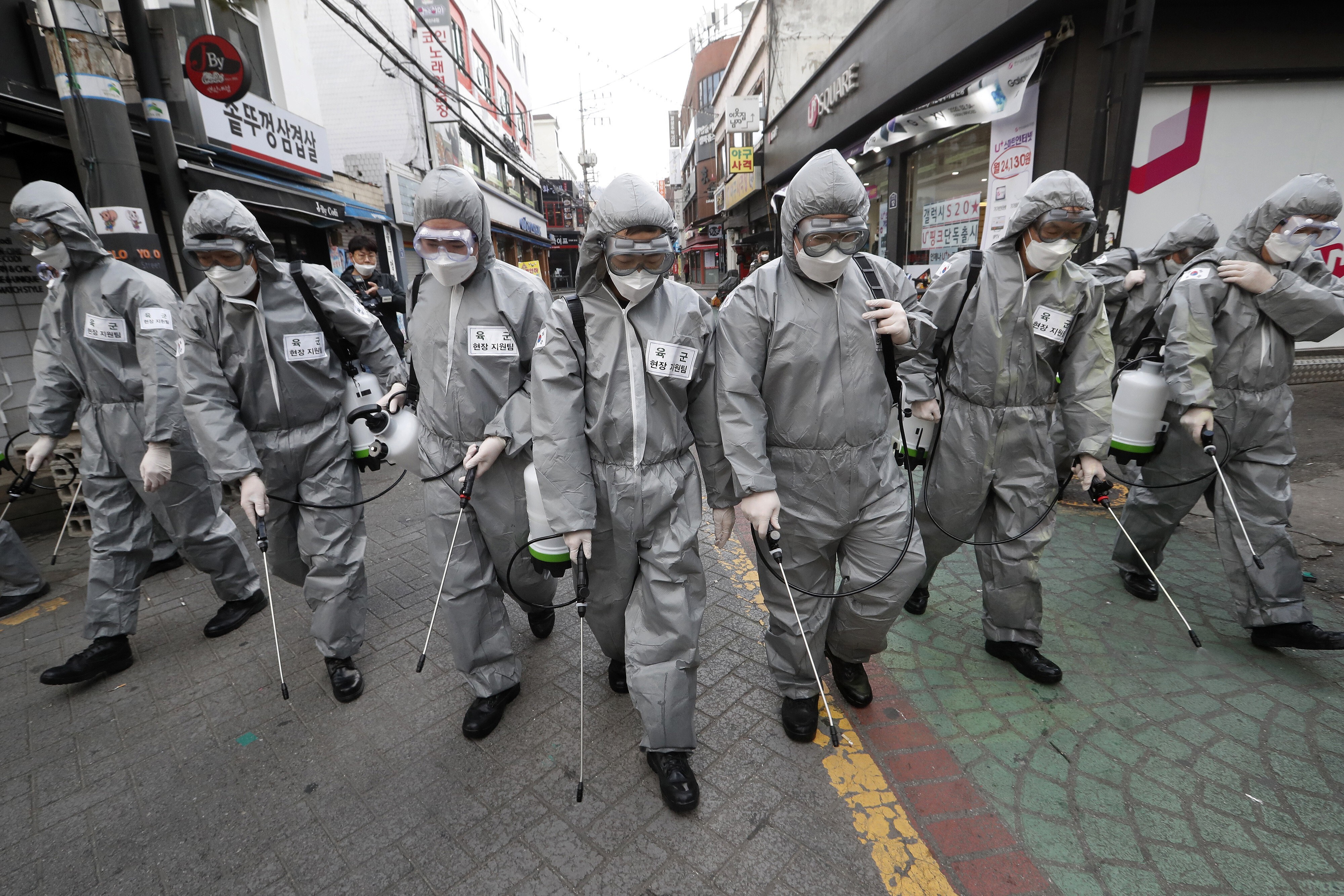 Soldiers wearing protective suits spray disinfectant as a precaution against coronavirus in Seoul, South Korea, on March 4. Photo: AP