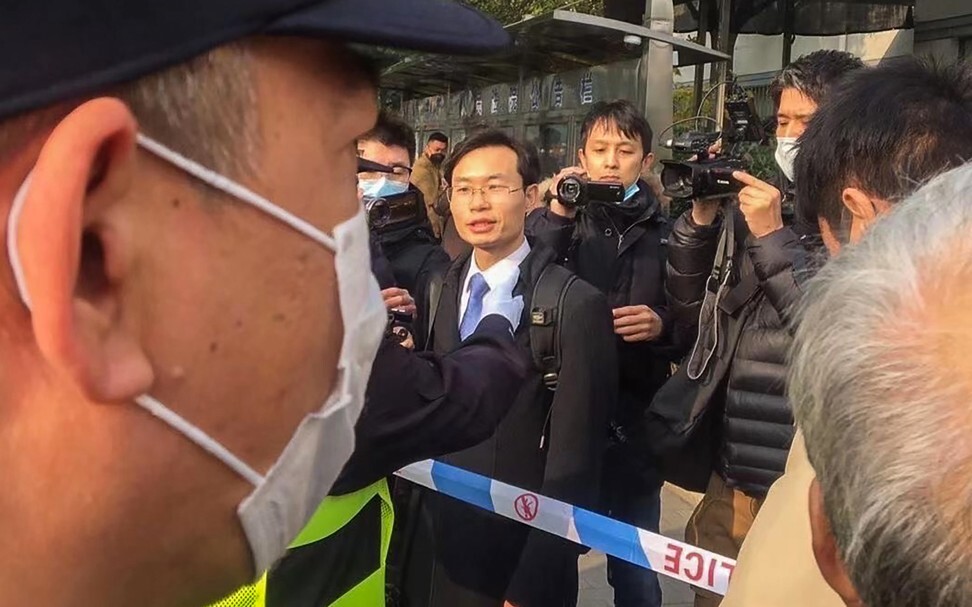 Zhang Zhan’s lawyer Zhang Keke (centre) is stopped by police while talking to media shortly before Zhang Zhan’s trial started on Monday. Photo: Handout