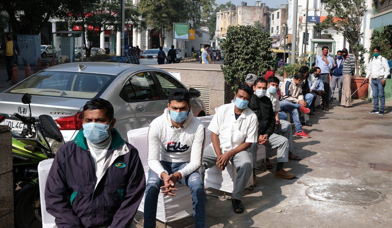 People in New Delhi wait in line for coronavirus tests. The Indian government has yet to lay out a specific schedule for when immunisations will begin. Photo: Bloomberg