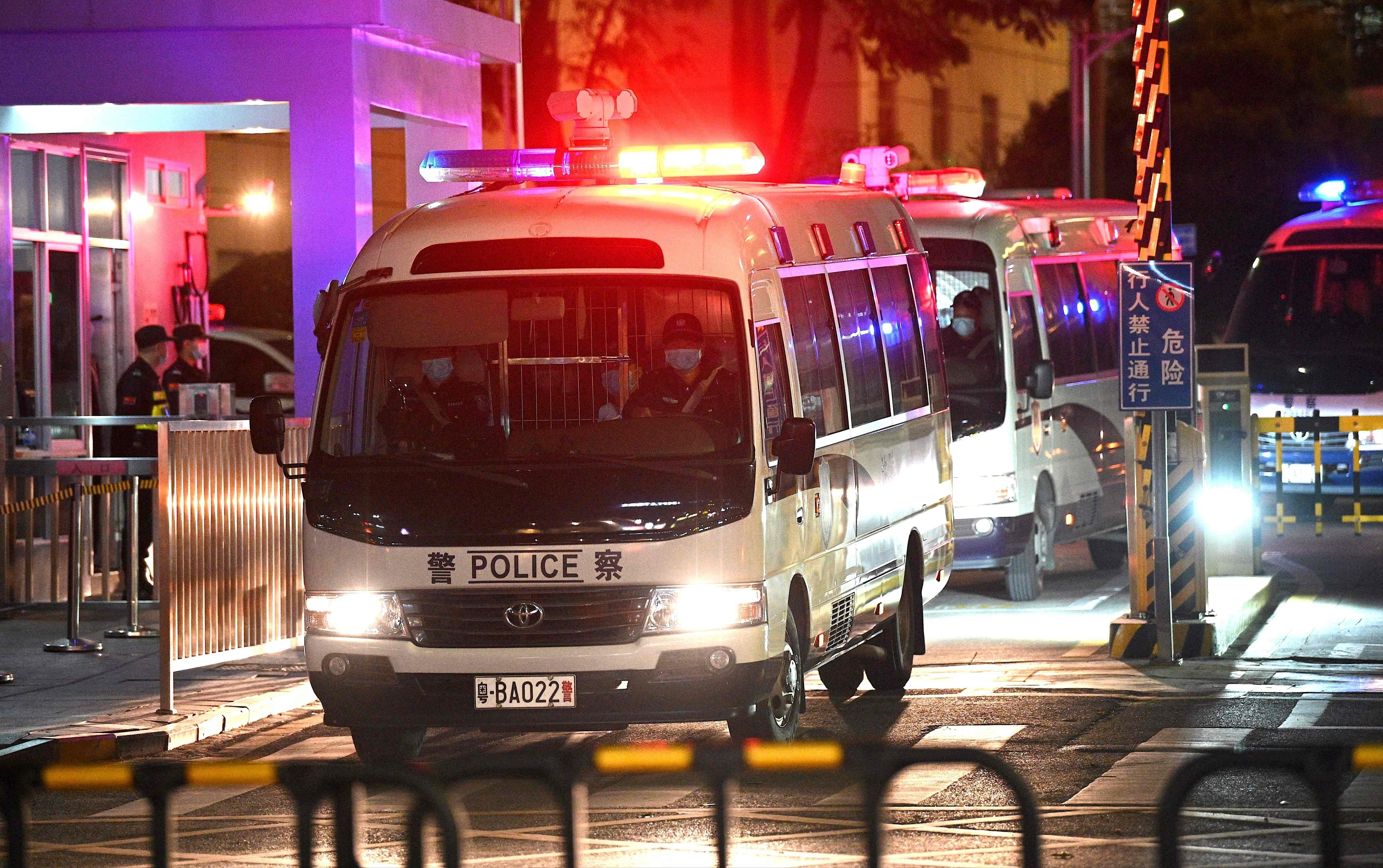 Police vehicles exit the Yantian People’s Court on Monday night. Photo: AFP