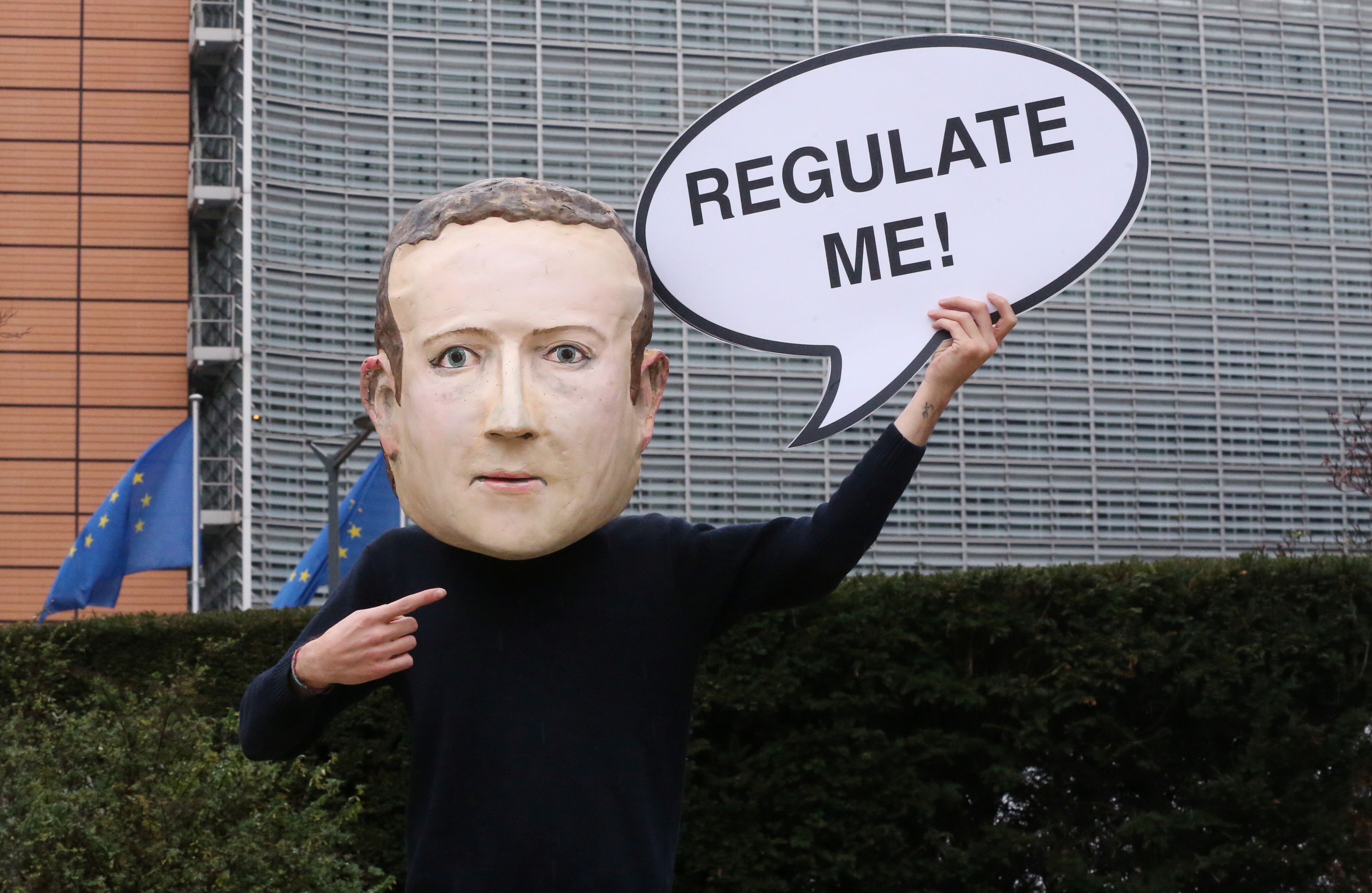 An activist wears a Mark Zuckerberg mask at a protest in Brussels, Belgium, on December 15. The US antitrust lawsuit against Facebook is a step towards the reregulating of information. Photo: Reuters