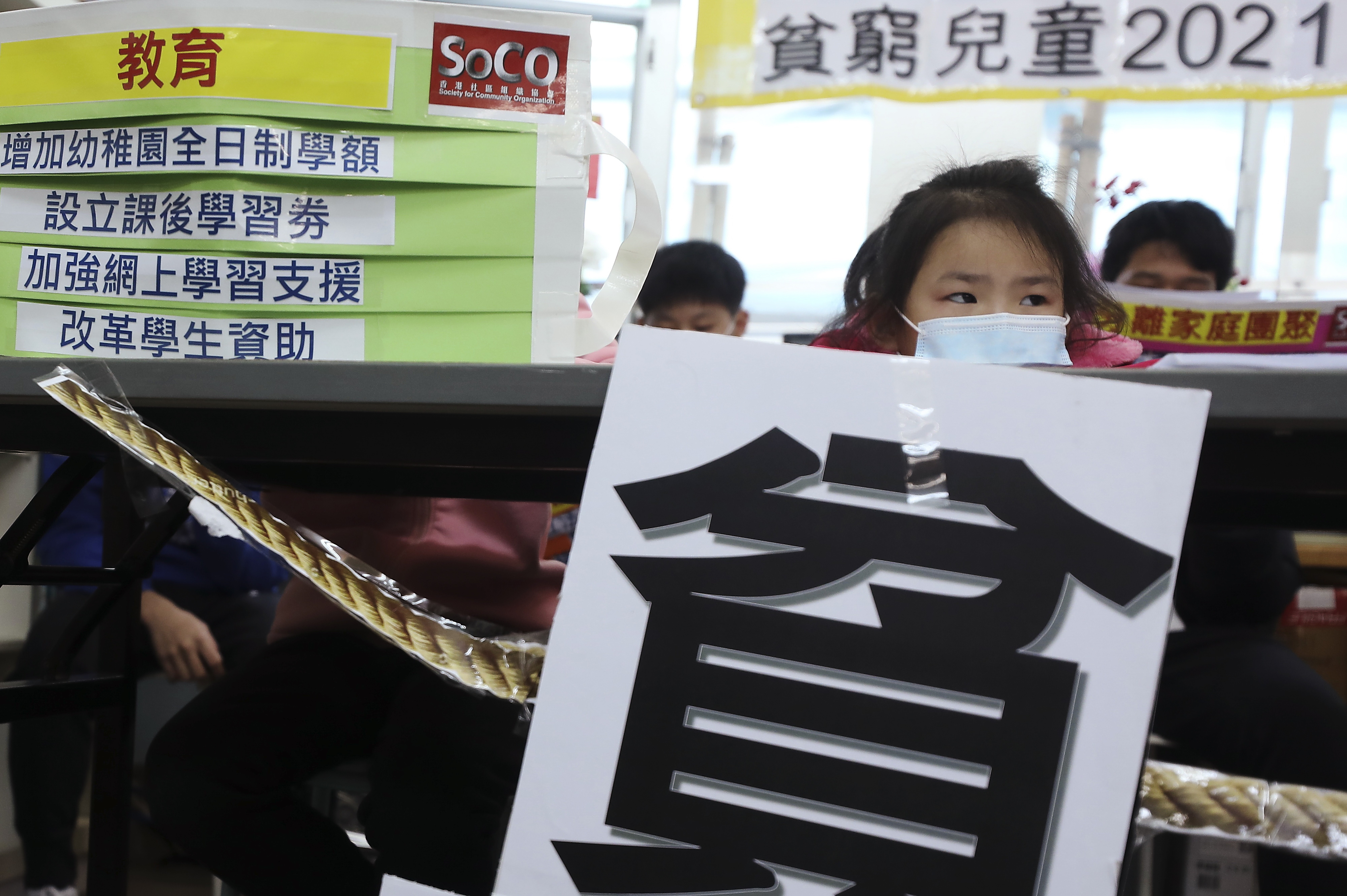 Children’s Rights Association ambassador Chen Shiqing, eight, peers over a table at a press conference announcing the release of the group’s annual report. Photo: Xiaomei Chen