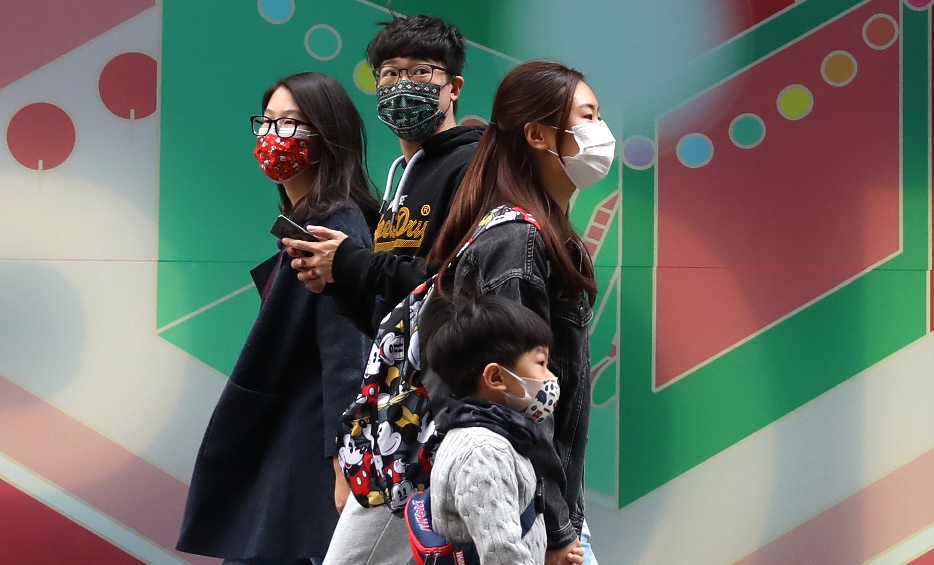 People wearing face masks are seen on a street in Hong Kong on December 25. Hongkongers who share the common goal of achieving democracy should live up to its principles and respect diverse opinions. Photo: Xinhua