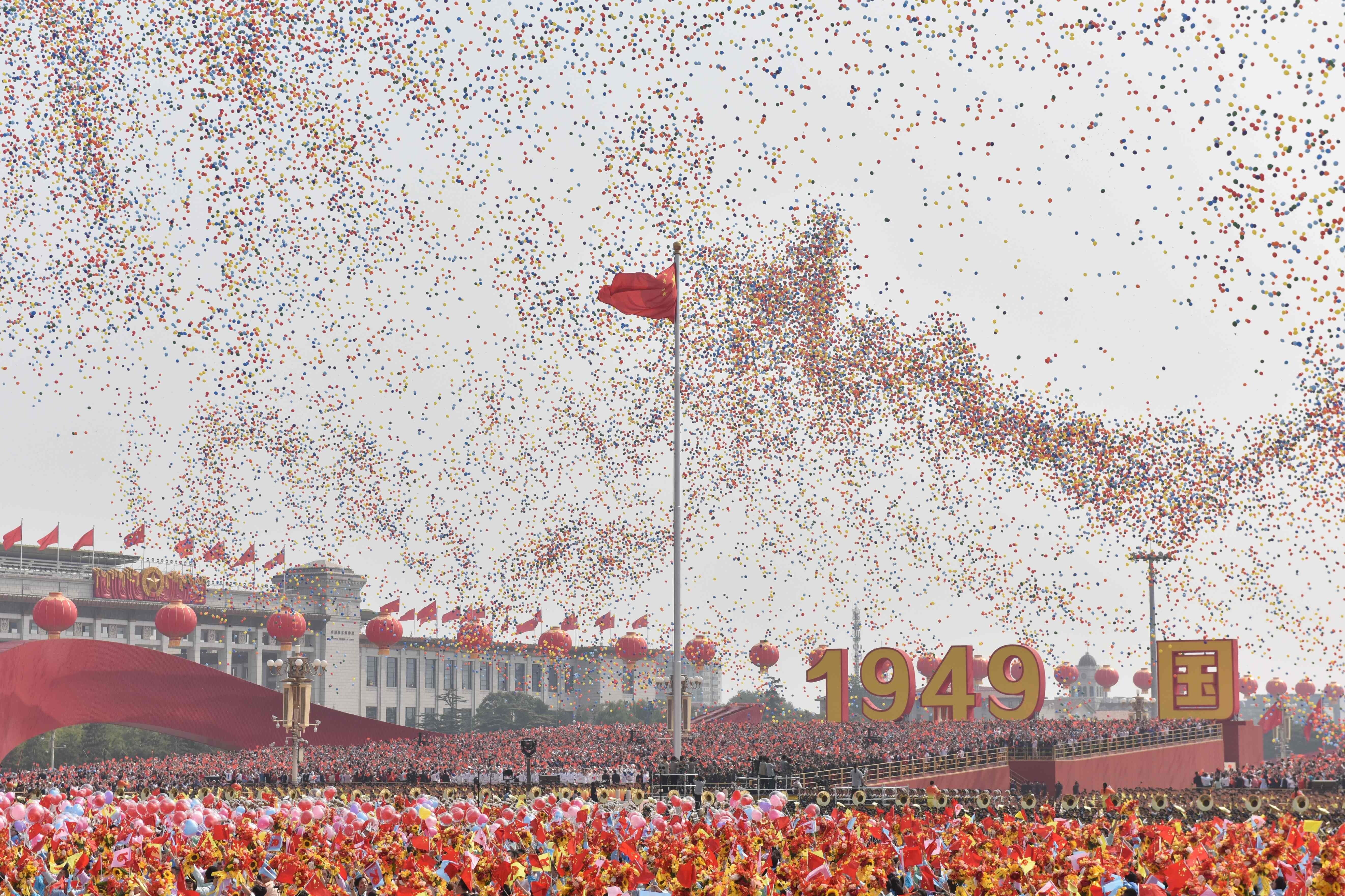 Balloons fly past the national flag at the end of a military parade at Tiananmen Square in Beijing on October 1, 2019, to mark the 70th anniversary of the founding of the People's Republic of China. Photo: AFP
