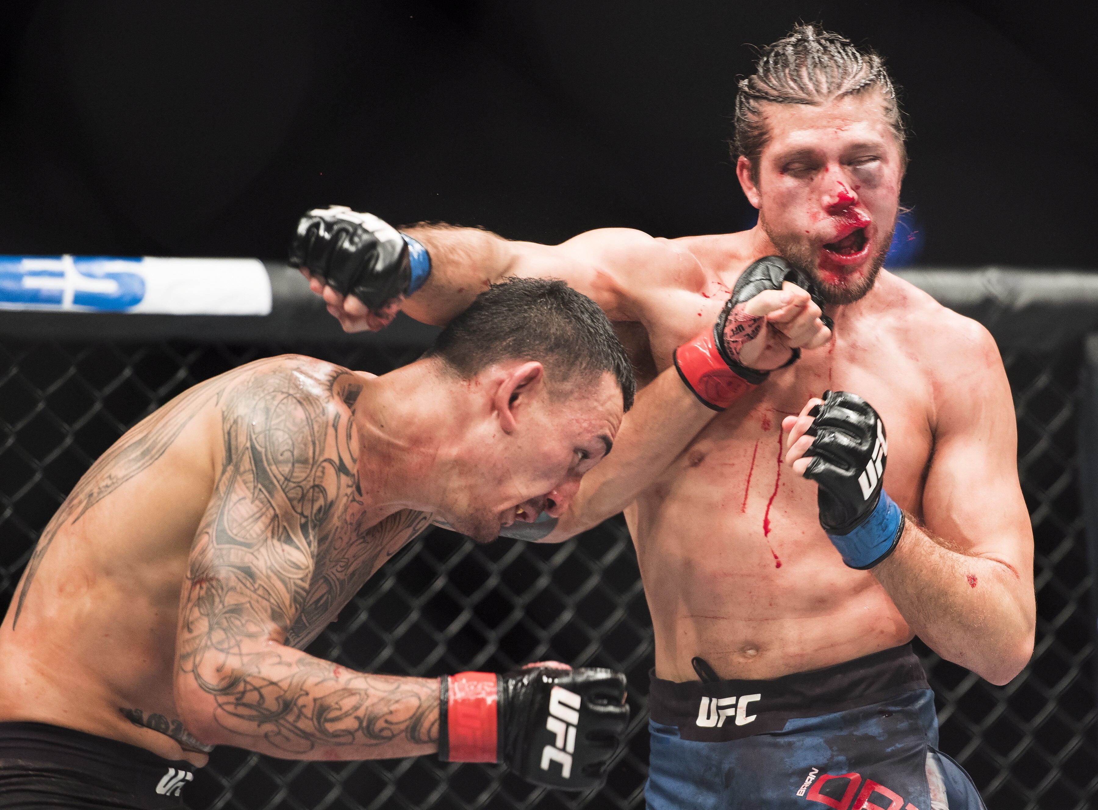 Max Holloway punches Brian Ortega en route to retaining his featherweight title via TKO on a medical stoppage at UFC 231. Photo: AP