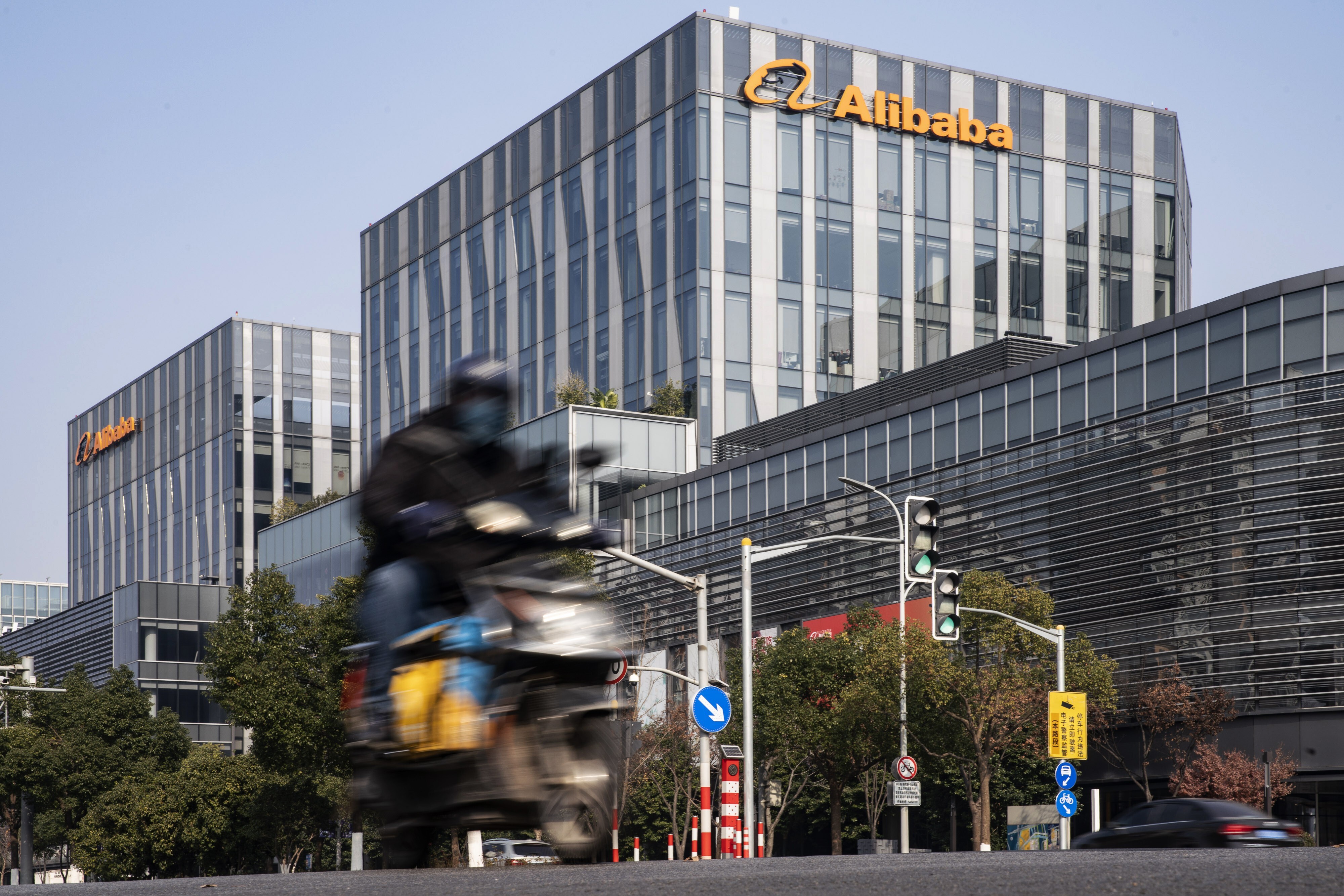A motorist travels past an Alibaba Group office building in Shanghai on December 24. China’s shift towards antitrust measures against Alibaba’s Ant Group and other tech giants could signal the start of painful deleveraging for some of the country’s most successful firms. Photo: Bloomberg