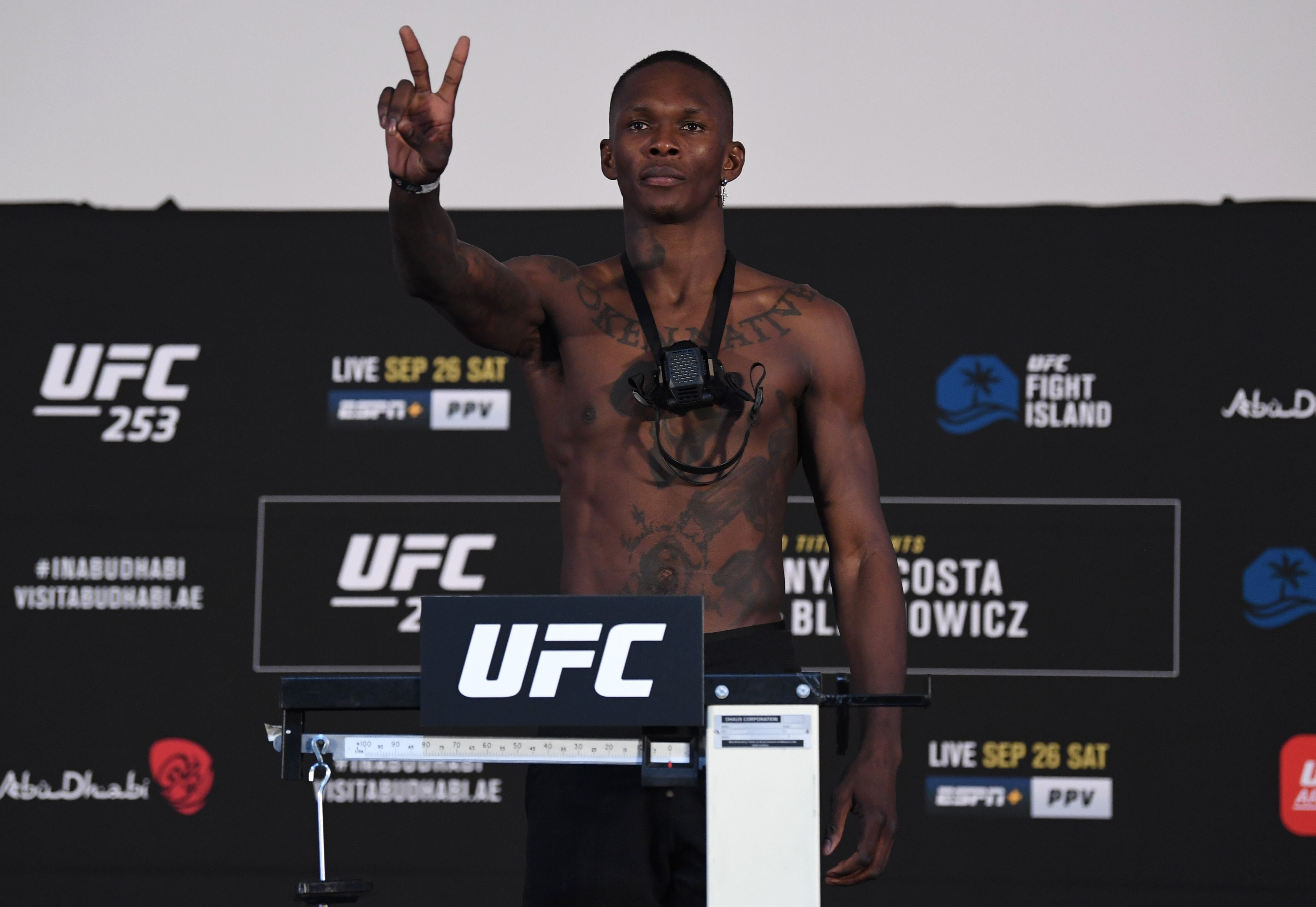 Israel Adesanya poses on the scale during the UFC 253 weigh-in. Photo: Josh Hedges/Zuffa LLC via Getty Images