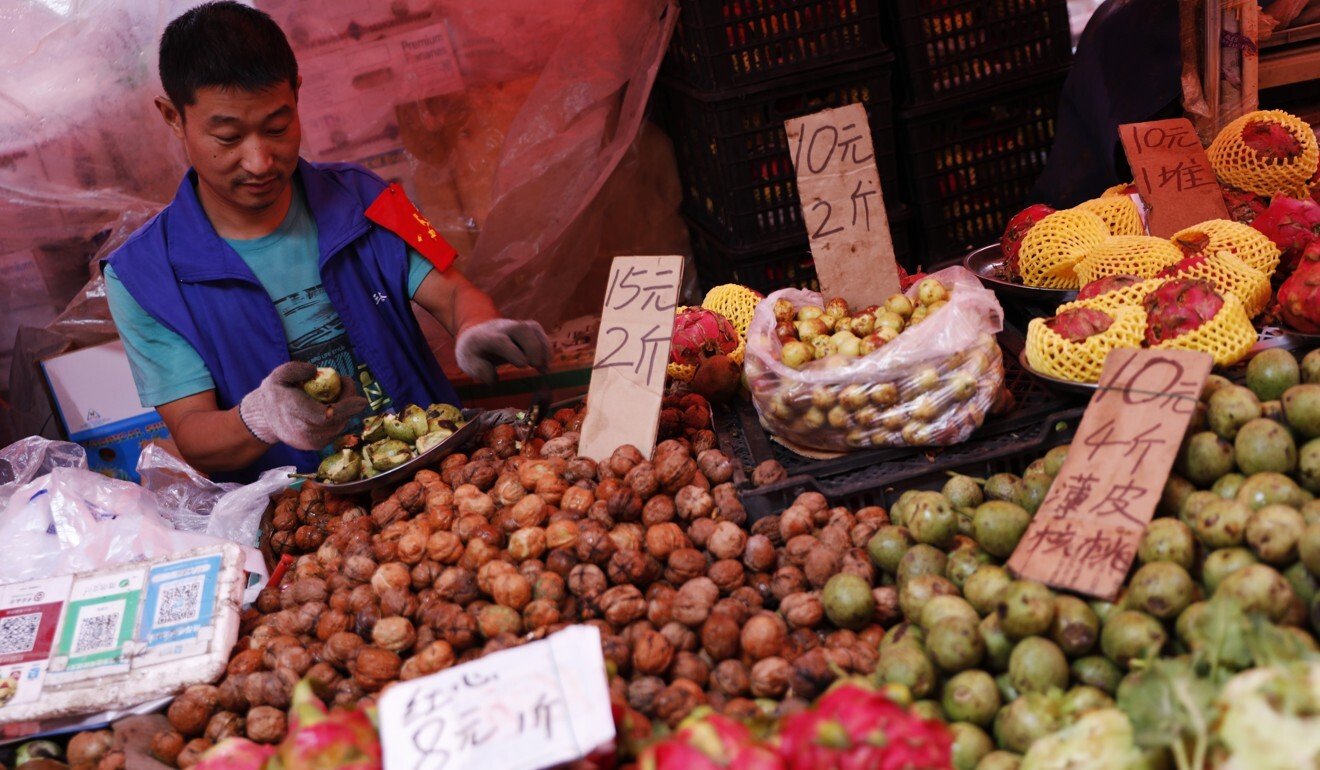 A traditional Chinese vendor sells goods at a market in Beijing, September 2019. Photo: EPA-EFE