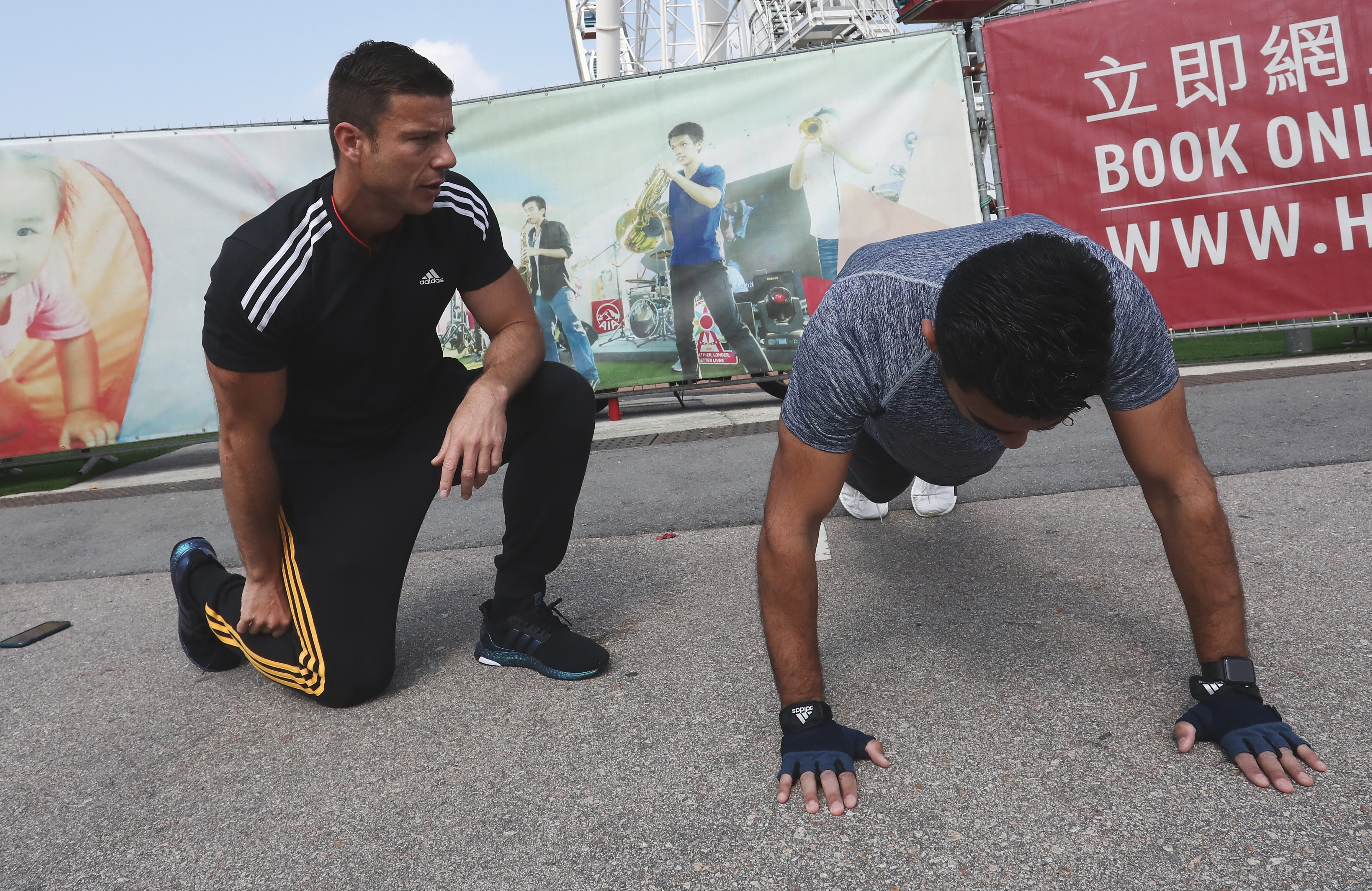 Personal trainer Ozgur “Ozzy” Irier hosts a personal training session with a client. Photo: Jonathan Wong