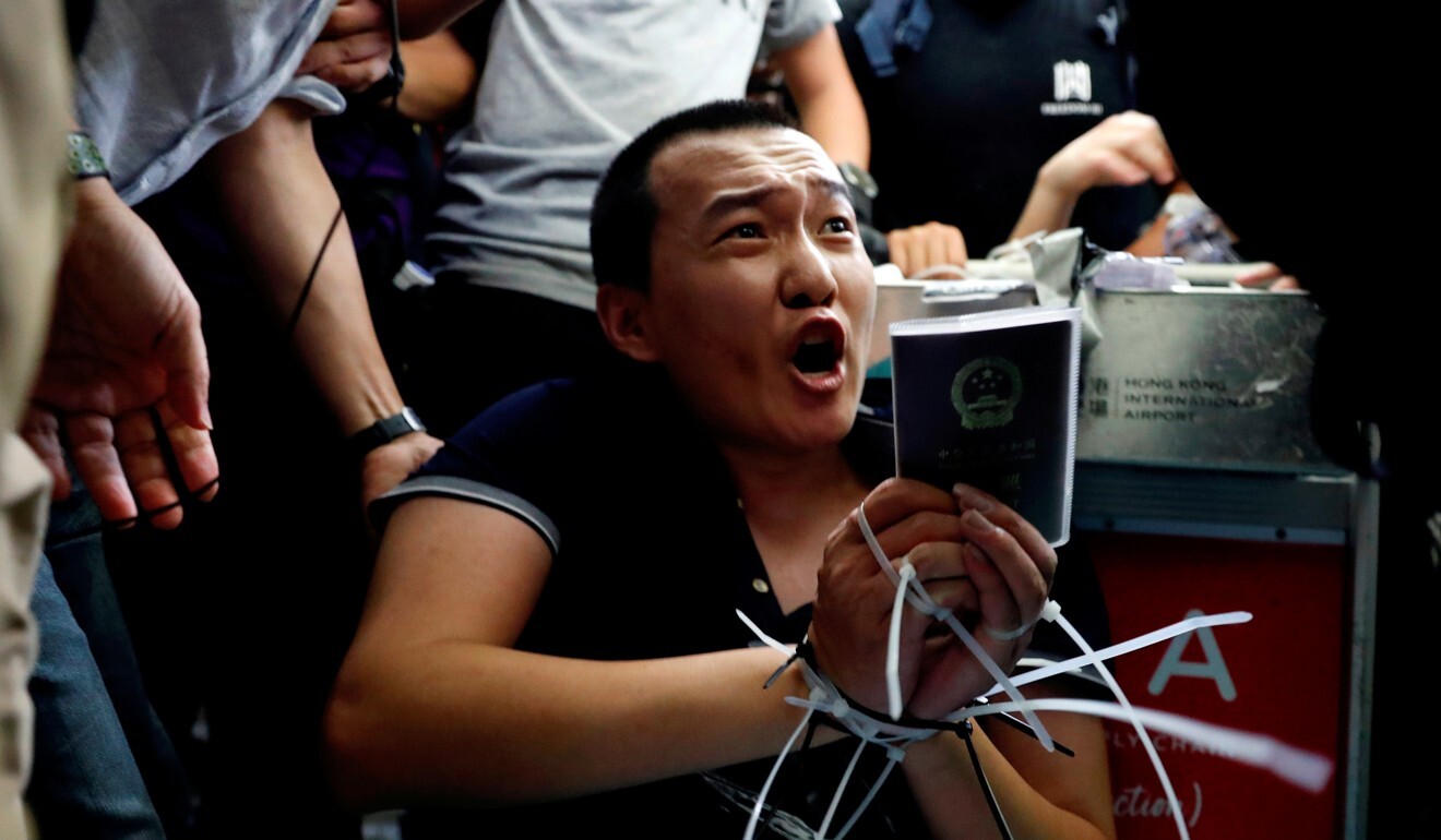 Fu Guohao is tied up by Hong Kong protesters who are suspicious of his identity. Photo: Reuters