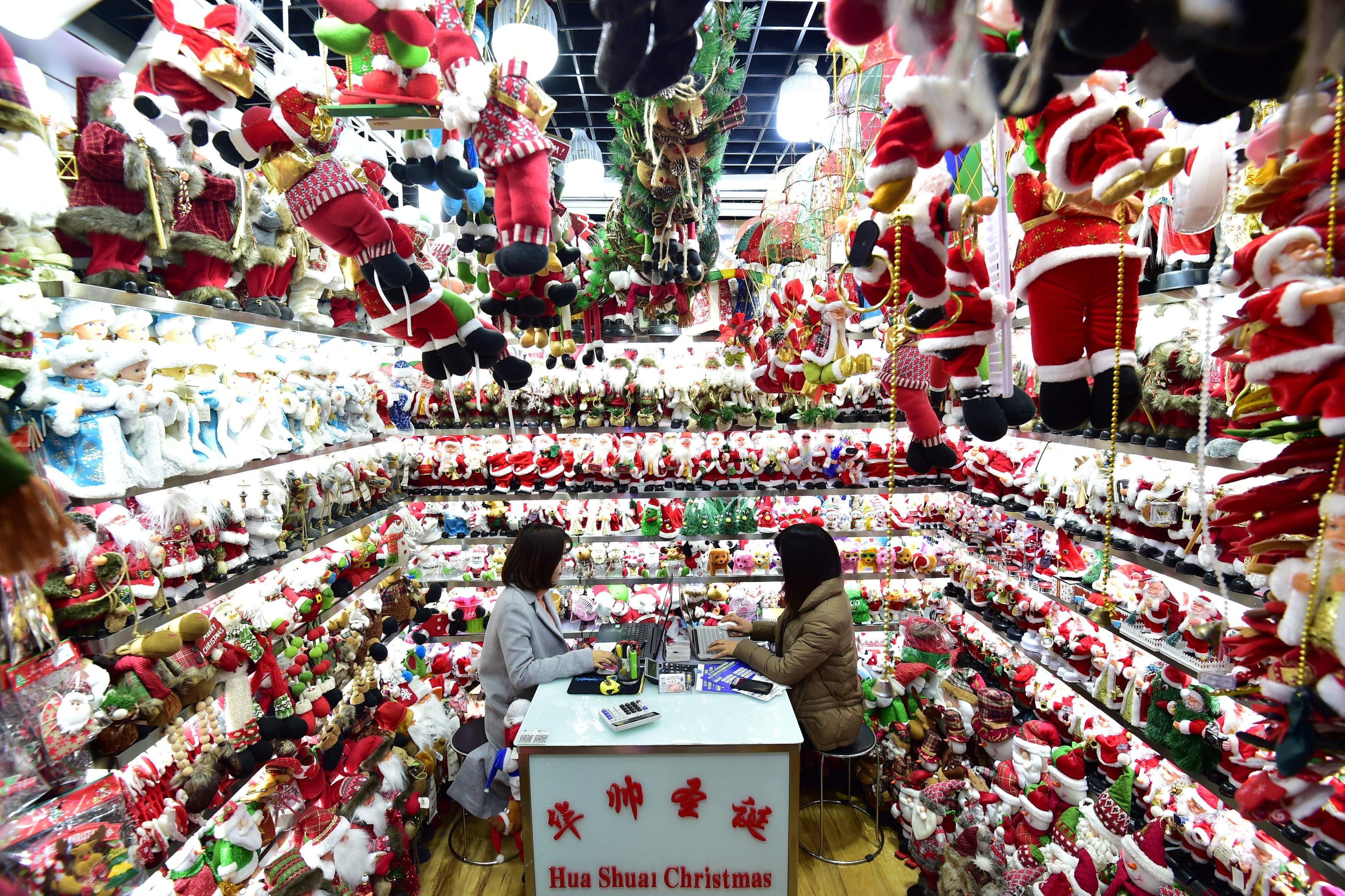 Women sit in a store selling Christmas products at the Yiwu Wholesale Market in Yiwu, in eastern Zhejiang province, on December 17, 2018. Photo: Reuters