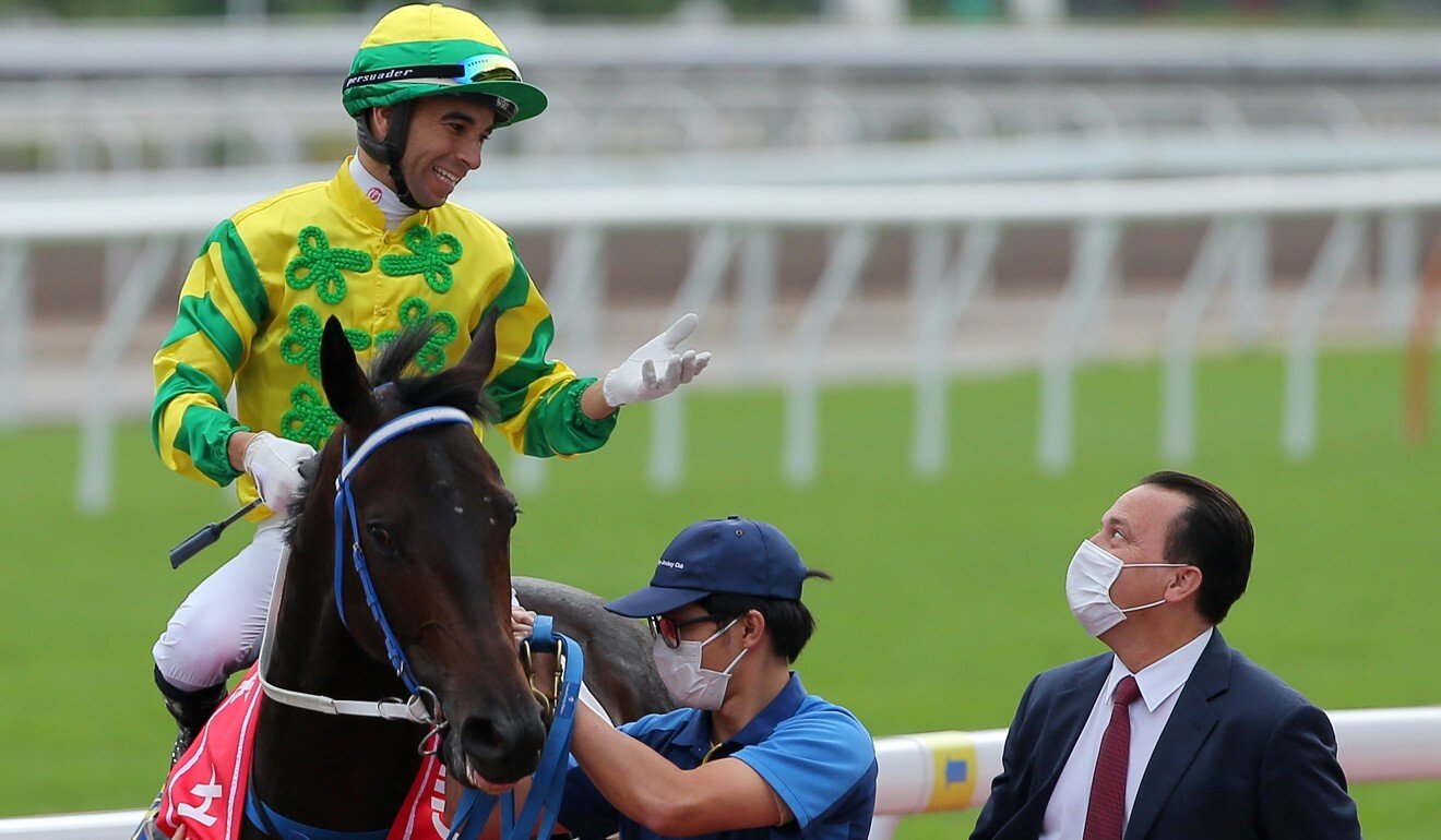 Jockey Joao Moreira chats to trainer Caspar Fownes after a Sky Darci win.