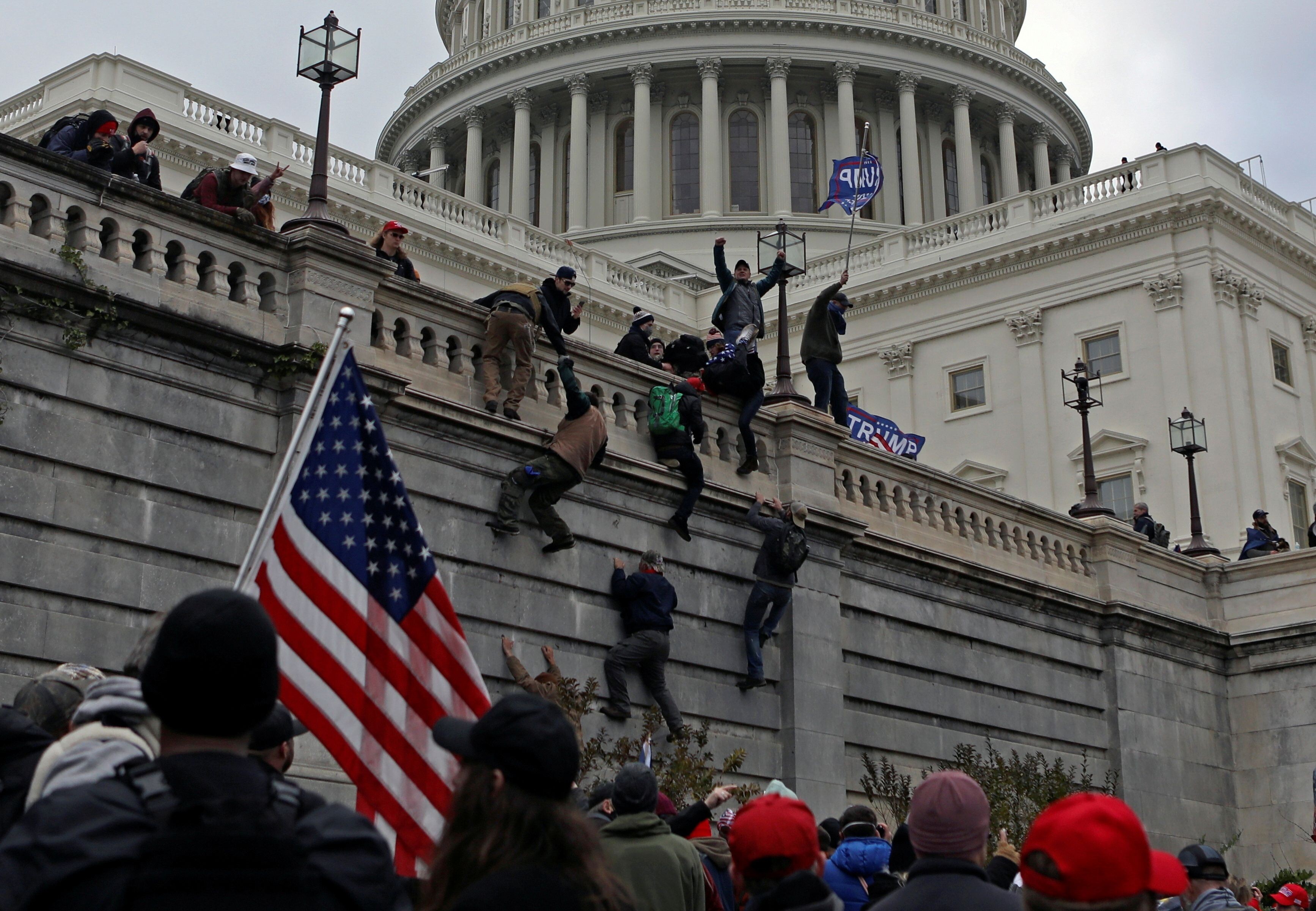 Supporters of President Donald Trump climb a wall at the US Capitol during a protest against certification of the election results by Congress on January 6. Beijing has seized on the chaos to criticise Washington. Photo: Reuters