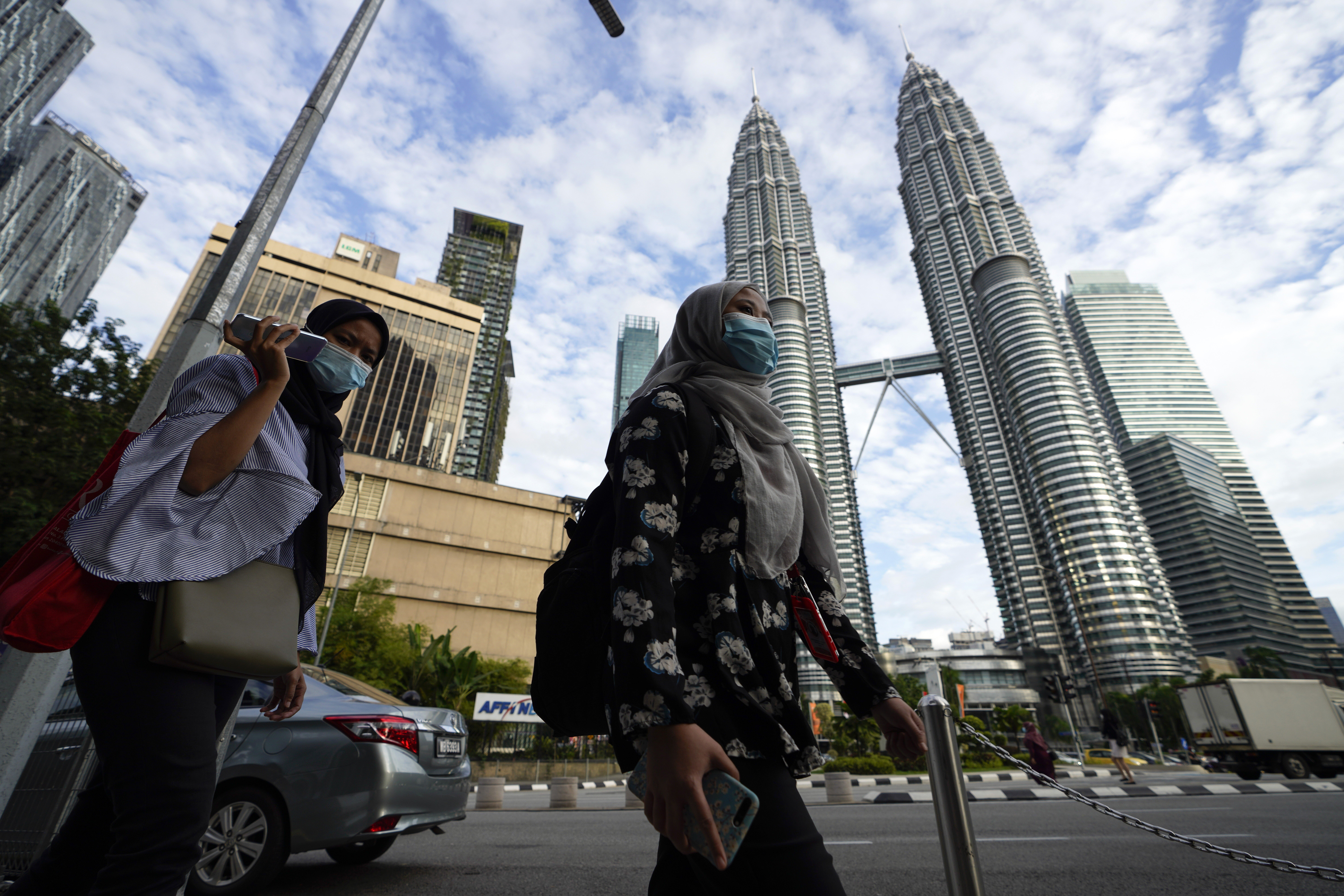 People clad in face masks seen in downtown Kuala Lumpur. Photo: AP