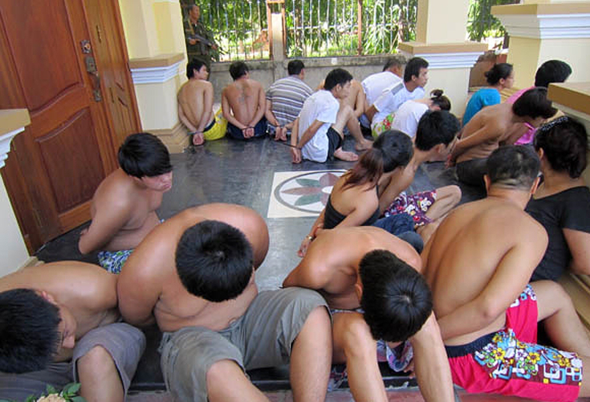 Chinese nationals sit with their hands bound after being arrested by Cambodian police in 2011 on suspicion of extorting money from victims abroad. Photo: AFP