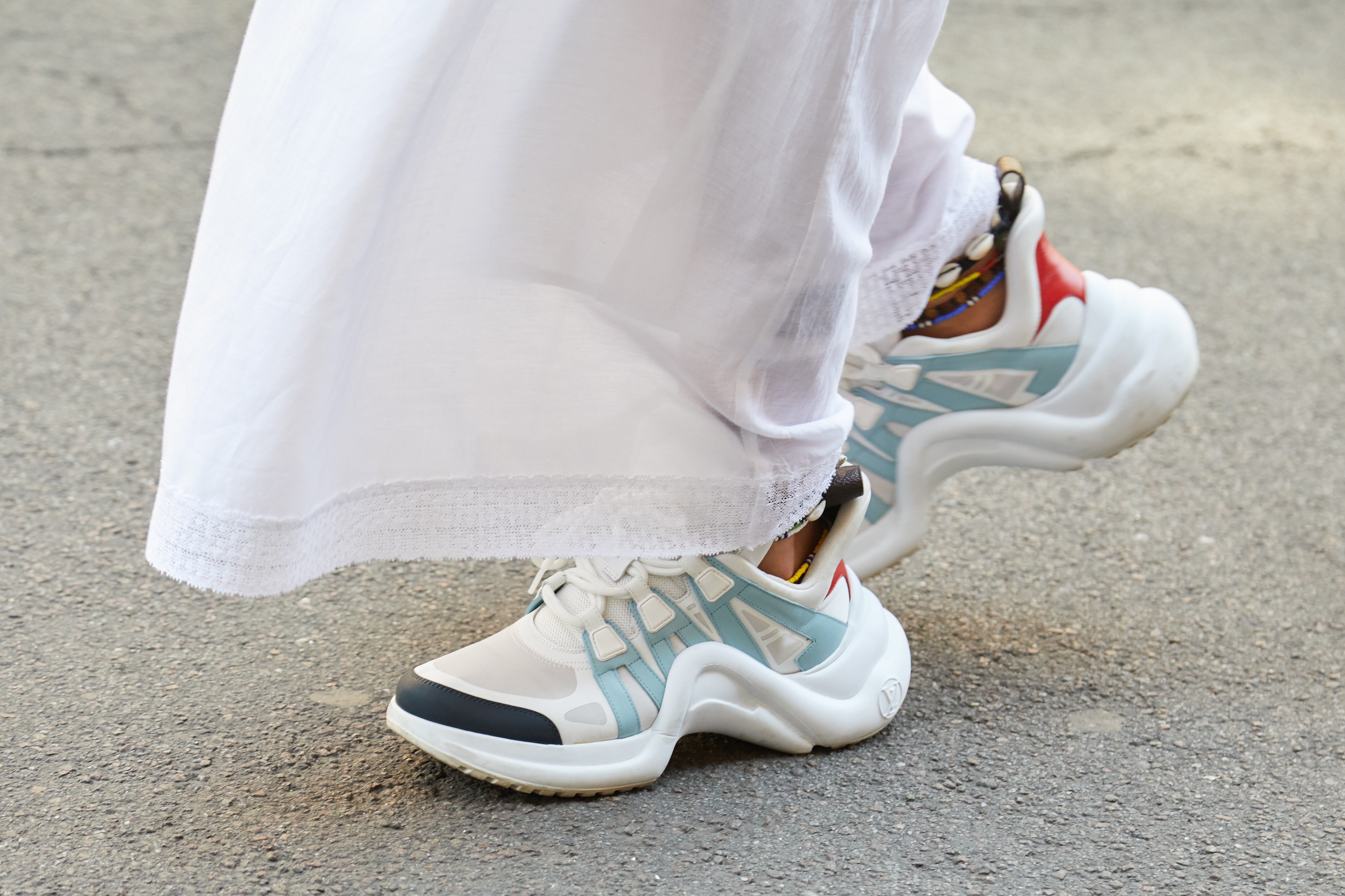 A pair of white and blue Louis Vuitton sneakers worn during Milan Fashion Week in 2018. Designers are increasingly pivoting to creating and selling sneakers as footwear trends move towards casual wear. Photo: Shutterstock
