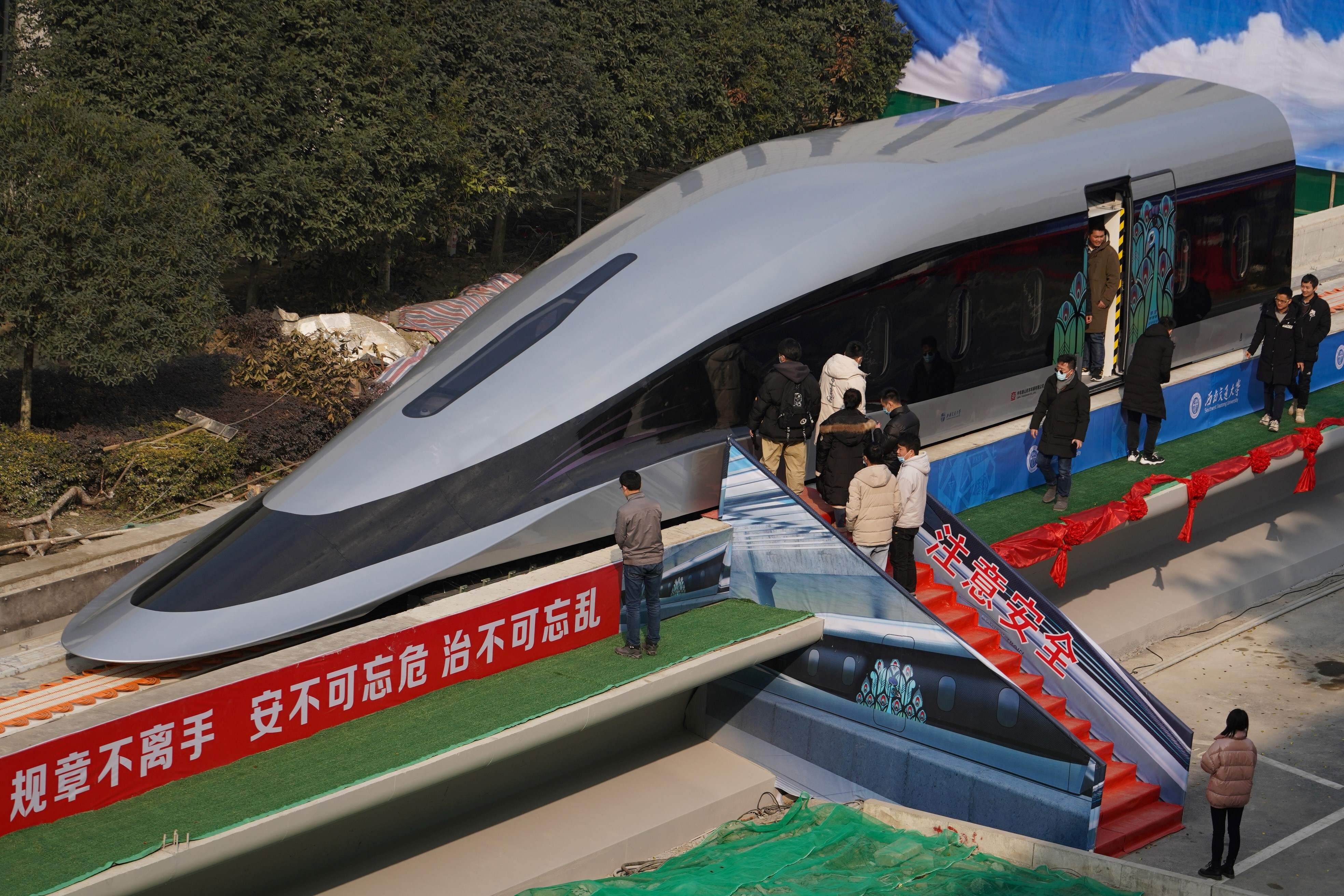 People inspect a prototype magnetic levitation train developed with high-temperature superconducting maglev technology in Chengdu, Sichuan province, on Wednesday. Photo: AFP