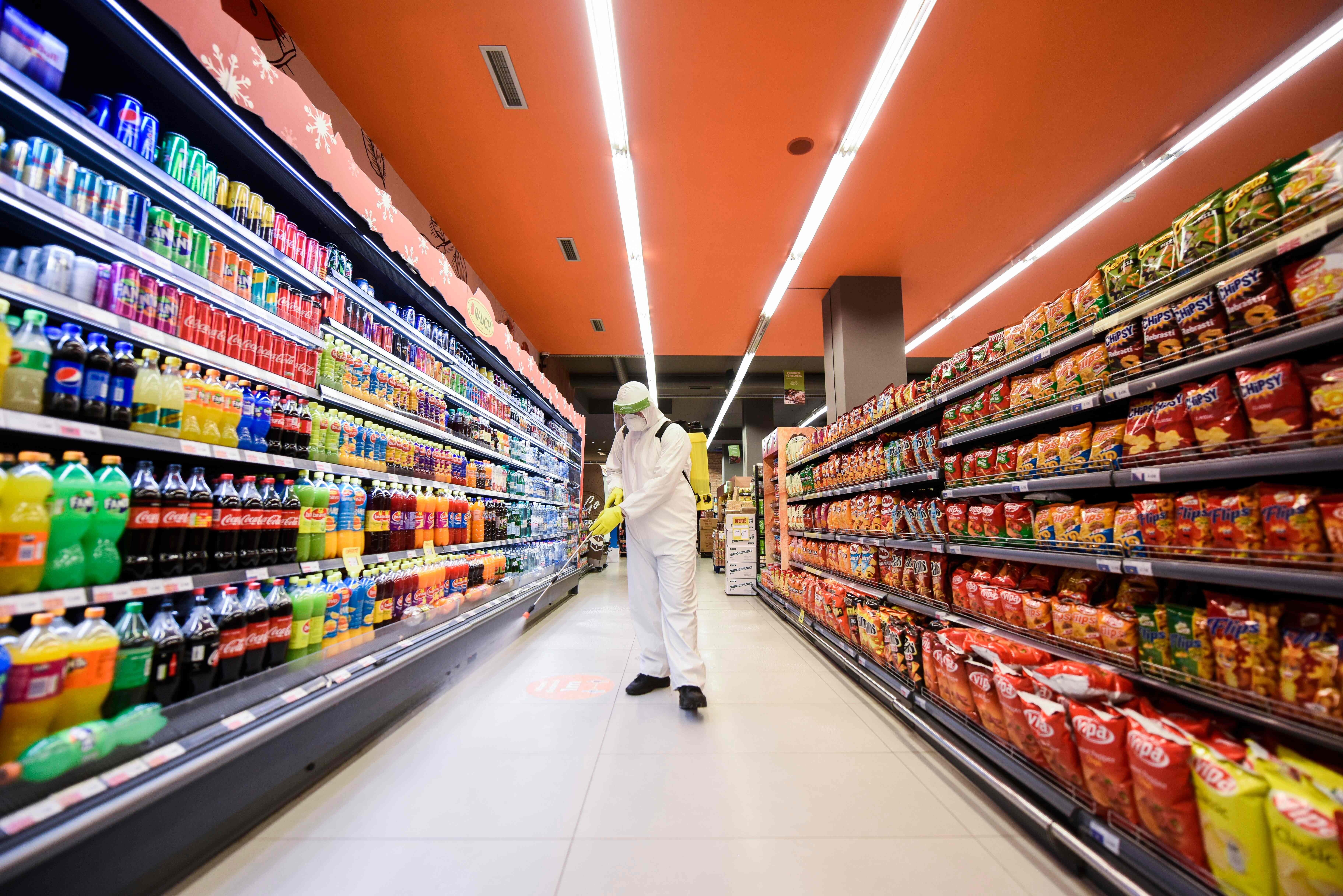 A worker disinfects the floor of a supermarket as a preventive measure against the spread of coronavirus. So much of the infrastructure of our civilisation is maintained by low-paid workers. Photo: AFP