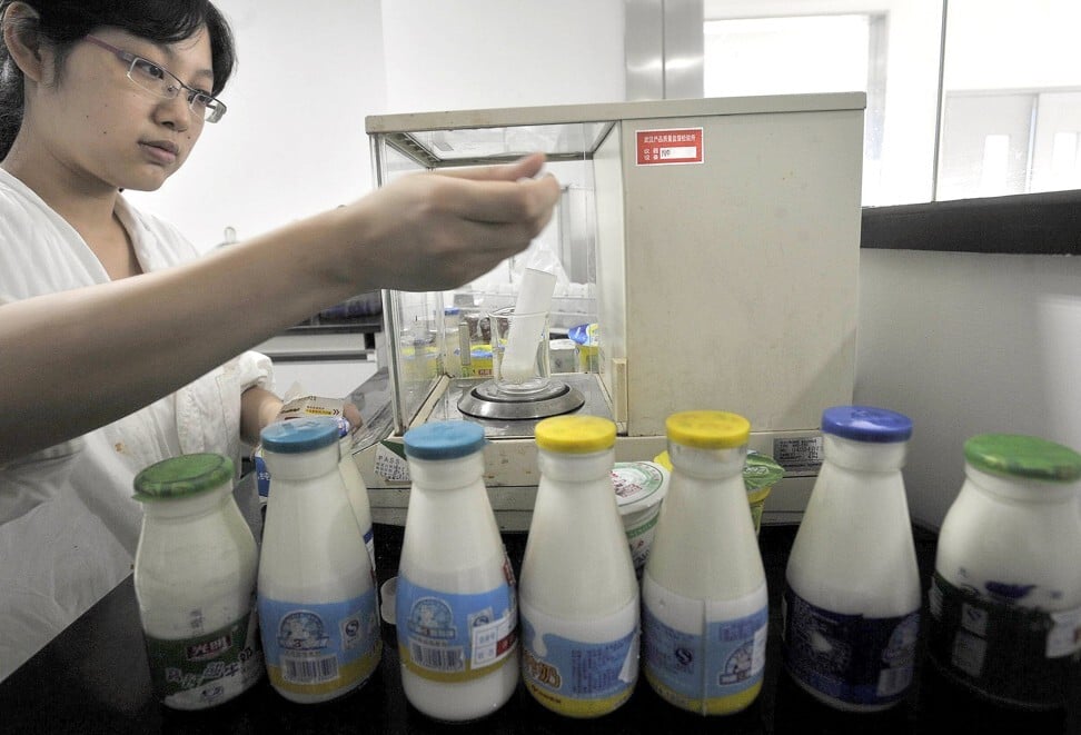 A lab technician performs tests on various milk products suspected to be tainted with melamine in the city of Wuhan in 2008. Photo: AFP