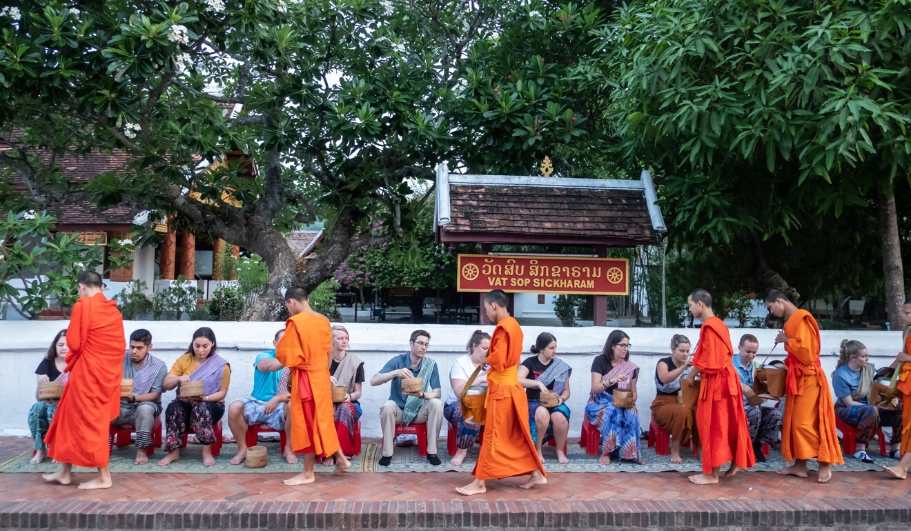 In pre-pandemic times, monks taking morning alms in the streets of Luang Prabang would be greeted by international tourists. Photo: Steve Thomas