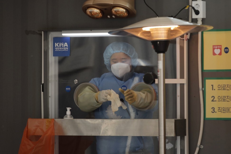 A medical worker in protective gear prepares to take a sample at a coronavirus testing site in Seoul, South Korea, on January 13. The country’s public pension fund, the National Pension Service, has also taken an active role in the crisis. Photo: AP