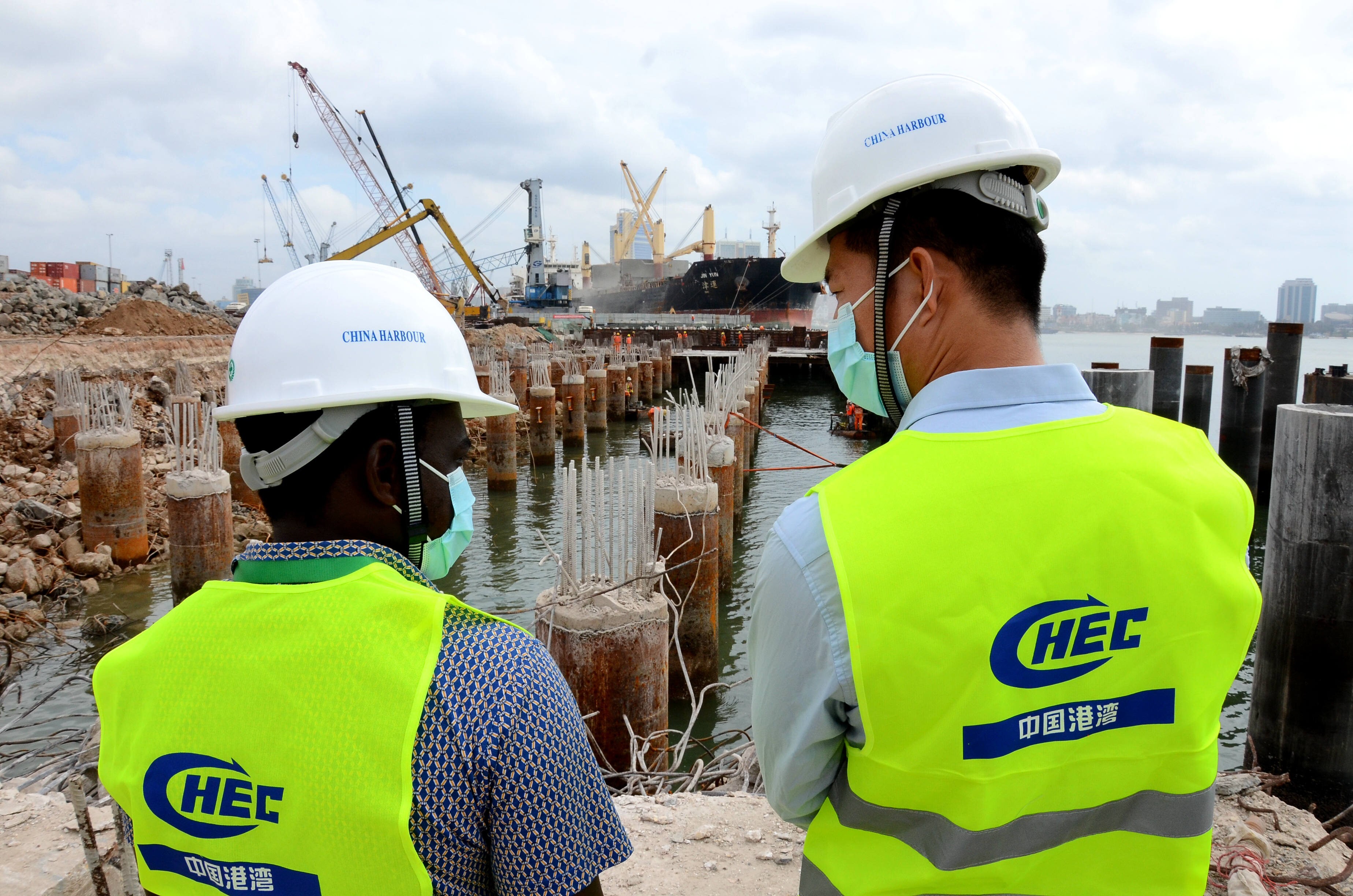 Engineers from Tanzania and China discuss construction plans at the building site of a project to upgrade the Dar es Salaam Port in Tanzania, on July 8, 2020. Photo: Xinhua
