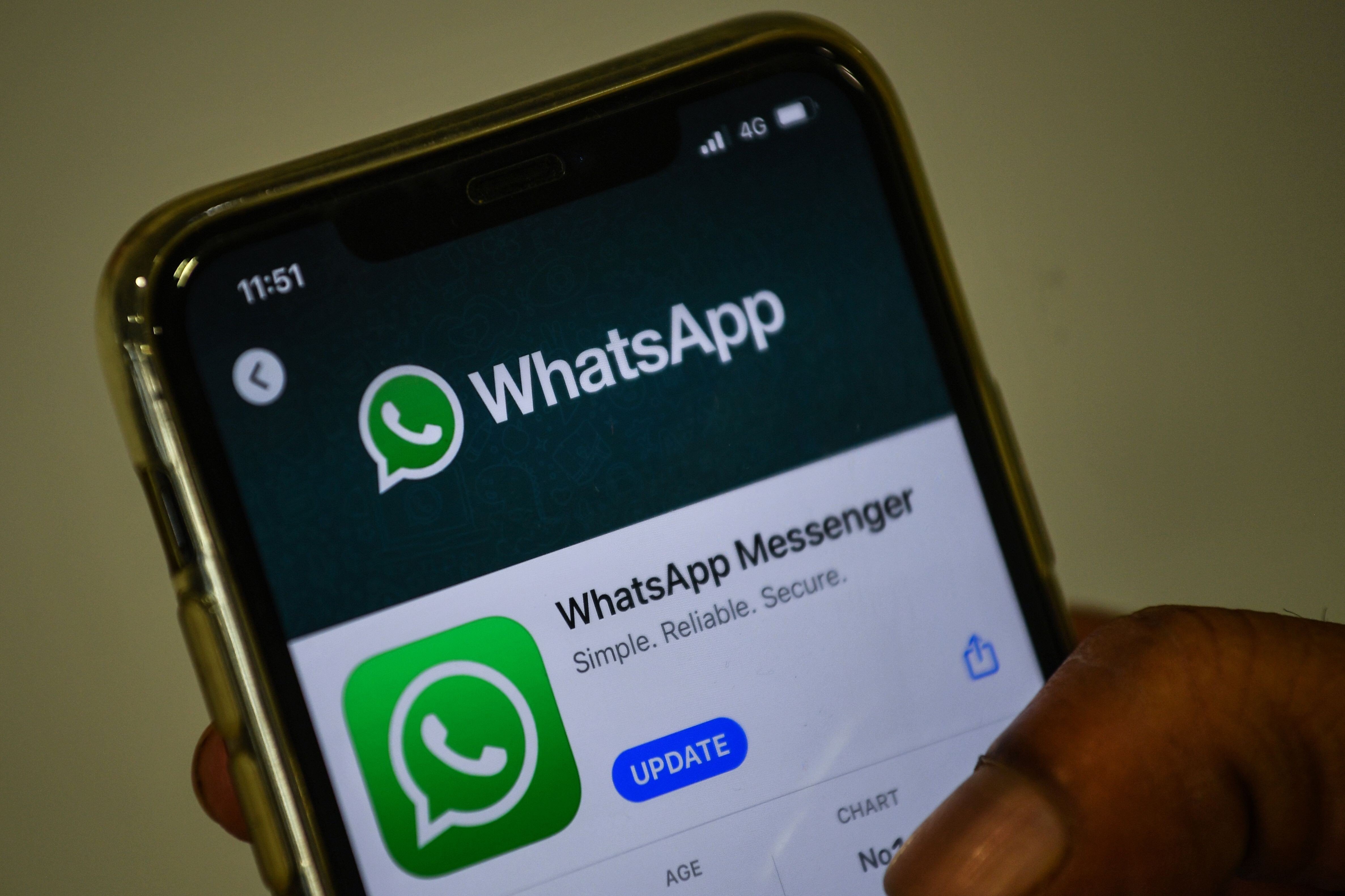A user in Mumbai updates Facebook's WhatsApp application on his mobile phone. Photo: AFP